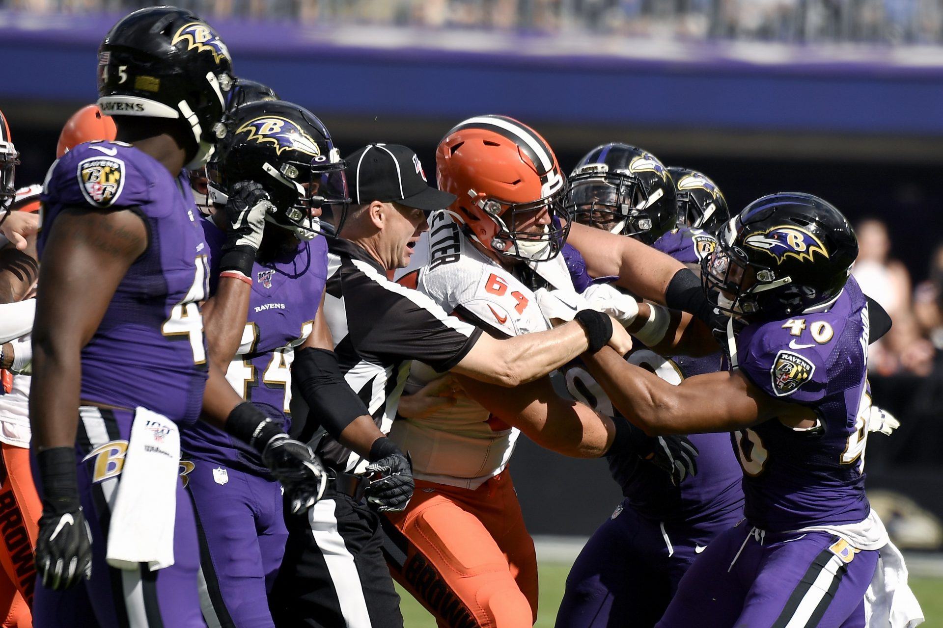 Cleveland Browns center JC Tretter (64) scuffles with Baltimore Ravens inside linebacker Kenny Young (40) during the second half of an NFL football game Sunday, Sept. 29, 2019, in Baltimore.