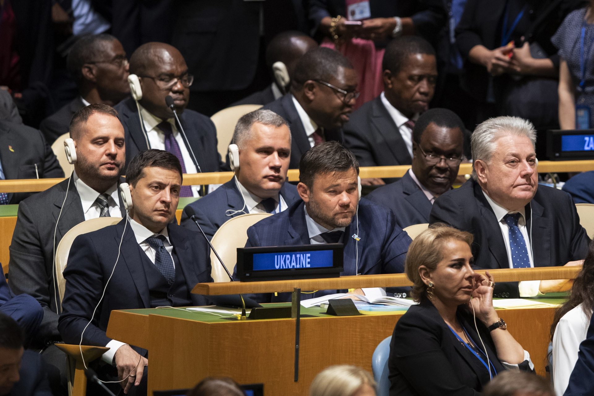 Delegates from Ukraine including President Volodymyr Zelensky, left, and Ambassador to U.N. Volodymyr Yelchenko, right, listen as U.S. President Donald Trump addresses the 74th session of the United Nations General Assembly at U.N. headquarters Tuesday, Sept. 24, 2019.