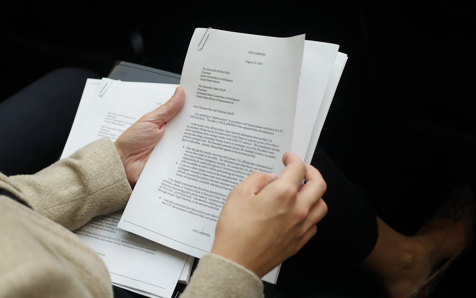 A member of the audience holds a copy of the Whistle-Blower Complaint letter sent to Senate and House Intelligence Committees during testimony by Acting Director of National Intelligence Joseph Maguire before the House Intelligence Committee on Capitol Hill in Washington, Thursday, Sept. 26, 2019.