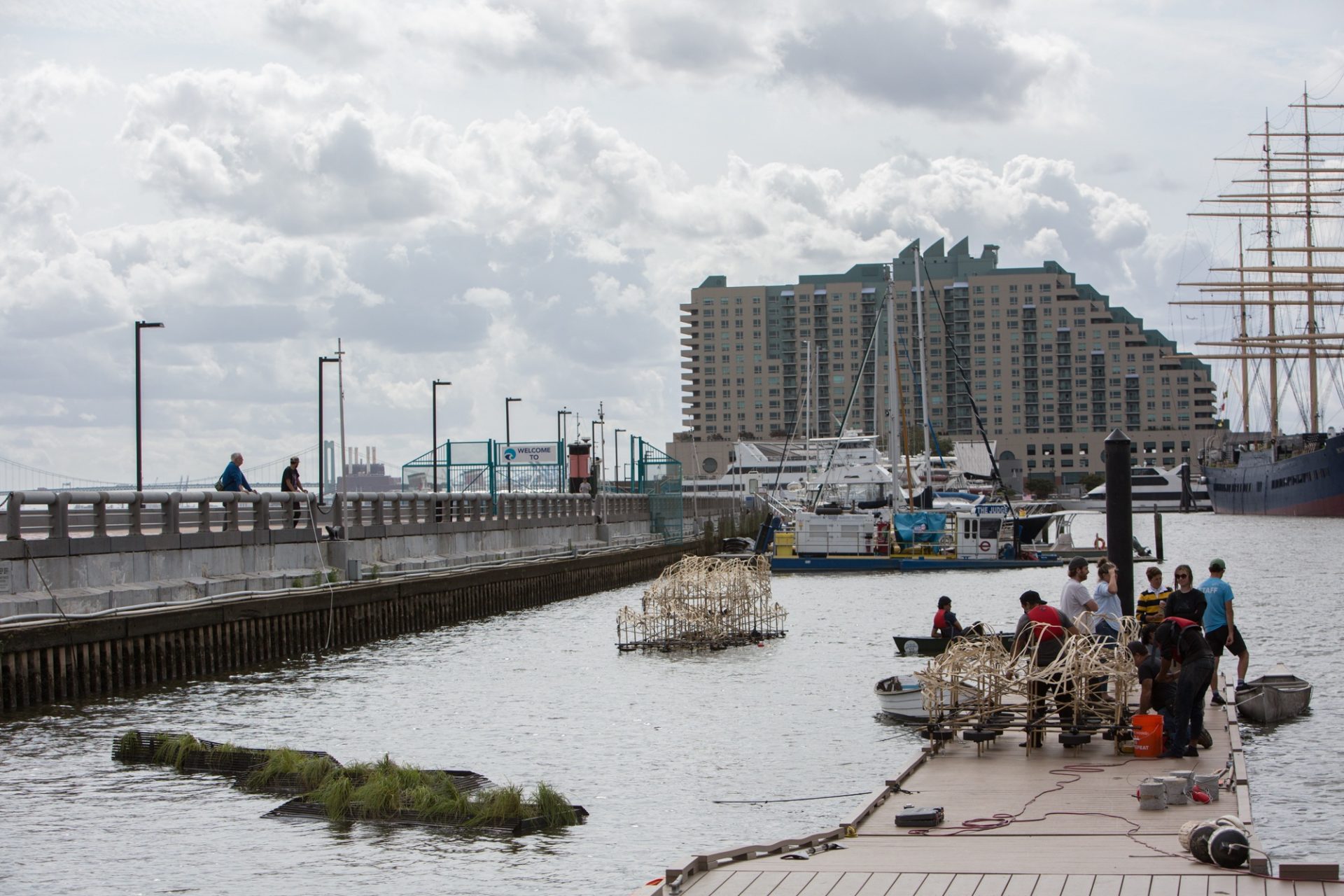The first half of Talasnik's sculpture settles into its spot in the Delaware River boat basin as the installers ready the second half.