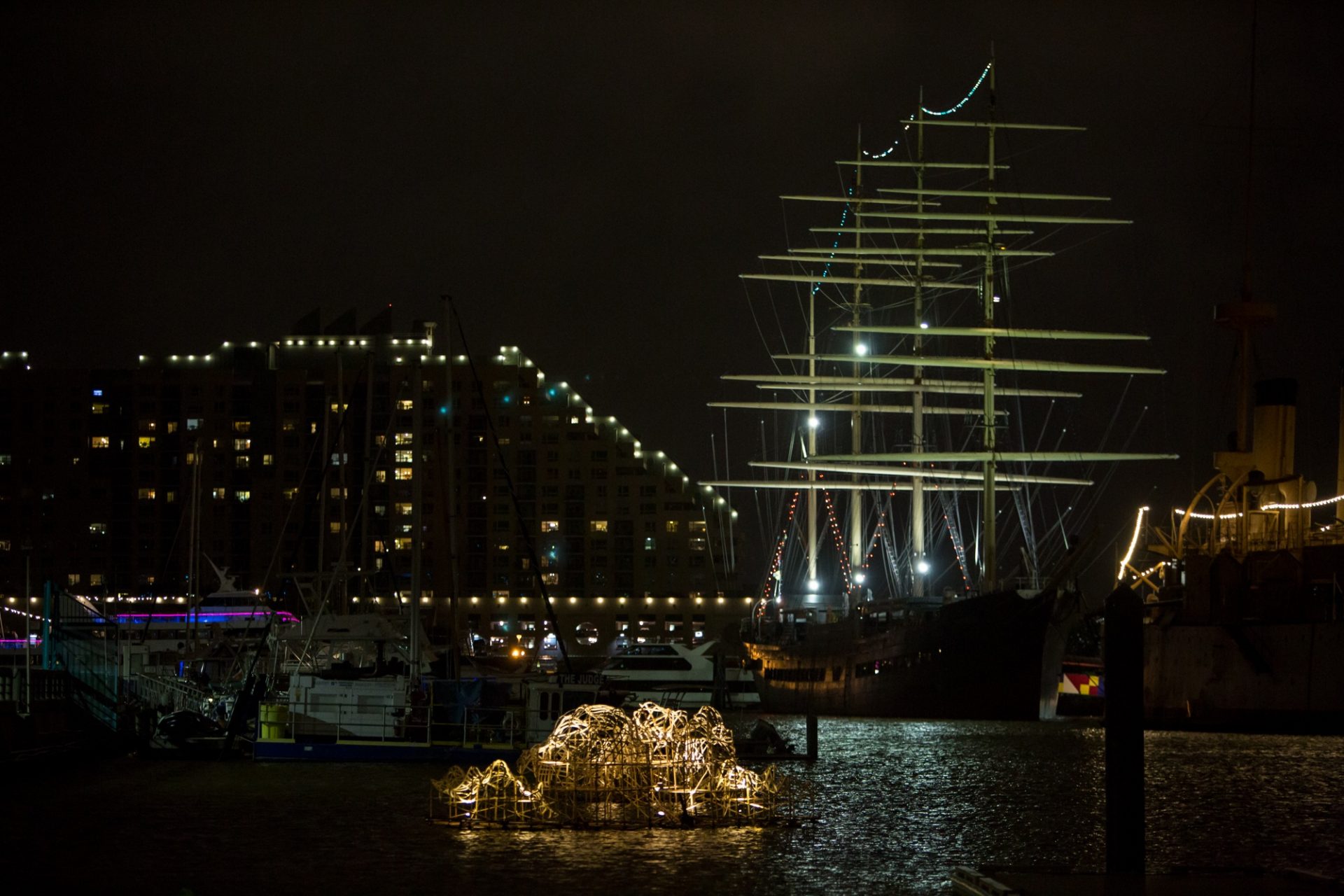 Stephen Talasnik's Endurance sits illuminated in the Delaware River boat basin ready for the opening of the FLOW exhibition. FLOW is a sculpture exhibit on the Delaware River in partnership with Philadelphia Sculptors and the Independence Seaport Museum.
