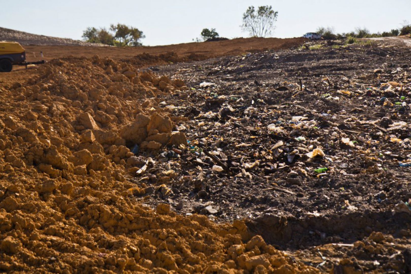 Trash still pokes through at the superfund site in Eastwick in September 2019.  