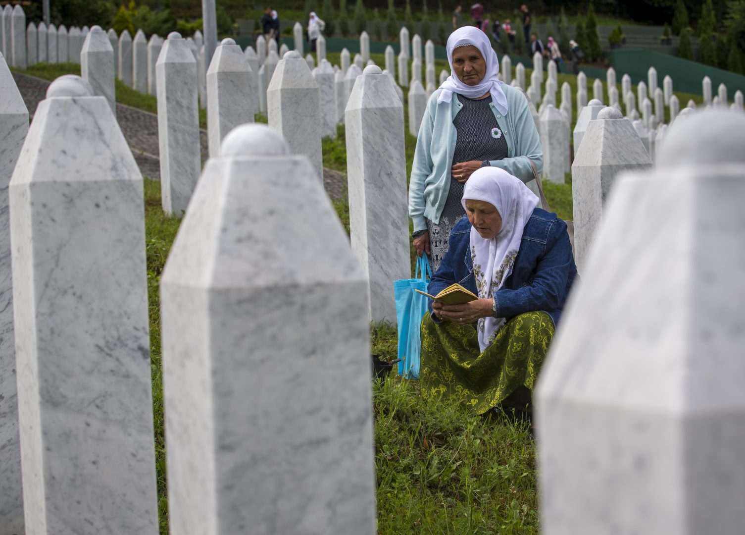 Relatives of victims pray as they visit the memorial cemetery in Potocari near Srebrenica, Bosnia, Wednesday, July 10, 2019. The remains of 33 victims of Srebrenica massacre will be buried on July 11, 2019, 24 years after Serb troops overran the eastern Bosnian Muslim enclave of Srebrenica and executed some 8,000 Muslim men and boys, which international courts have labeled as an act of genocide. 