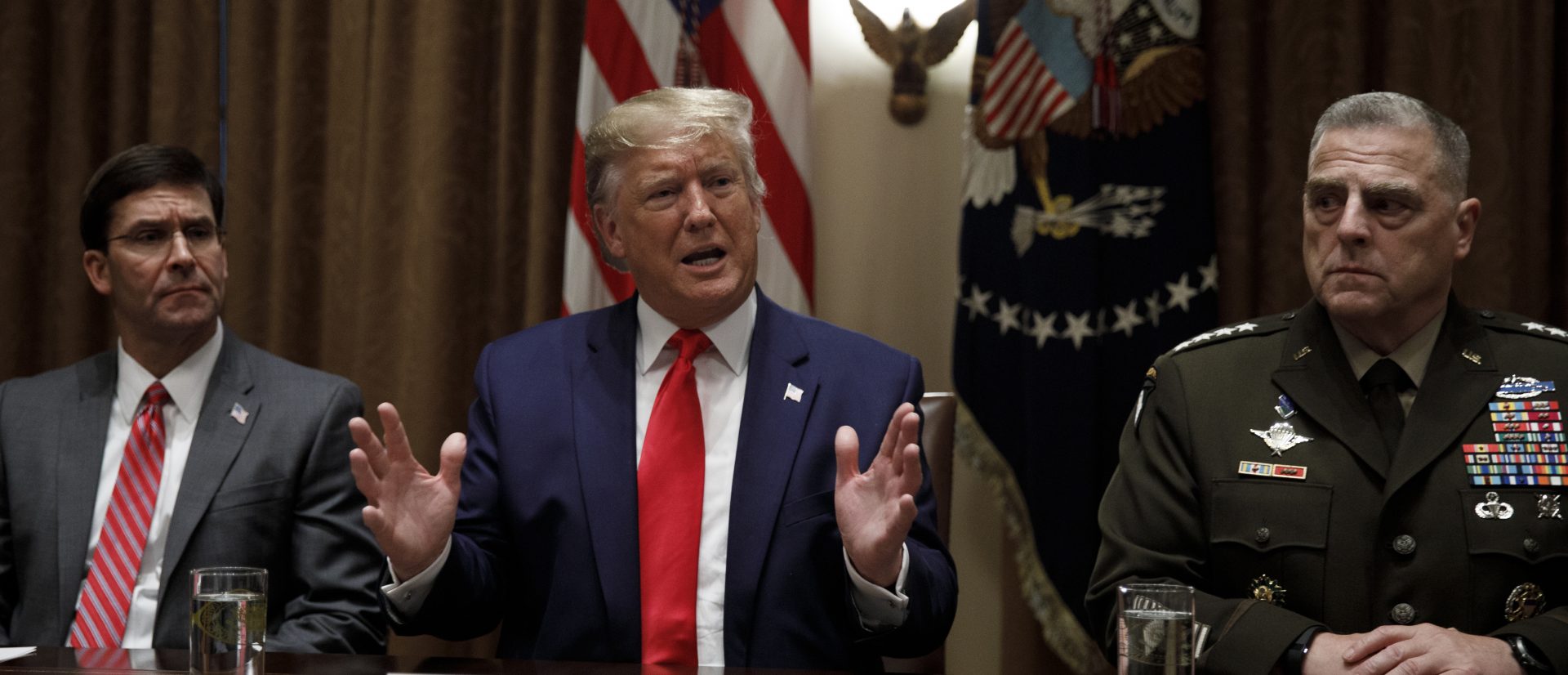 President Donald Trump, joined by from left, Defense Secretary Mark Esper, and Chairman of the Joint Chiefs of Staff Gen. Mark Milley, speaks to media during a briefing with senior military leaders in the Cabinet Room at the White House in Washington, Monday, Oct. 7, 2019.