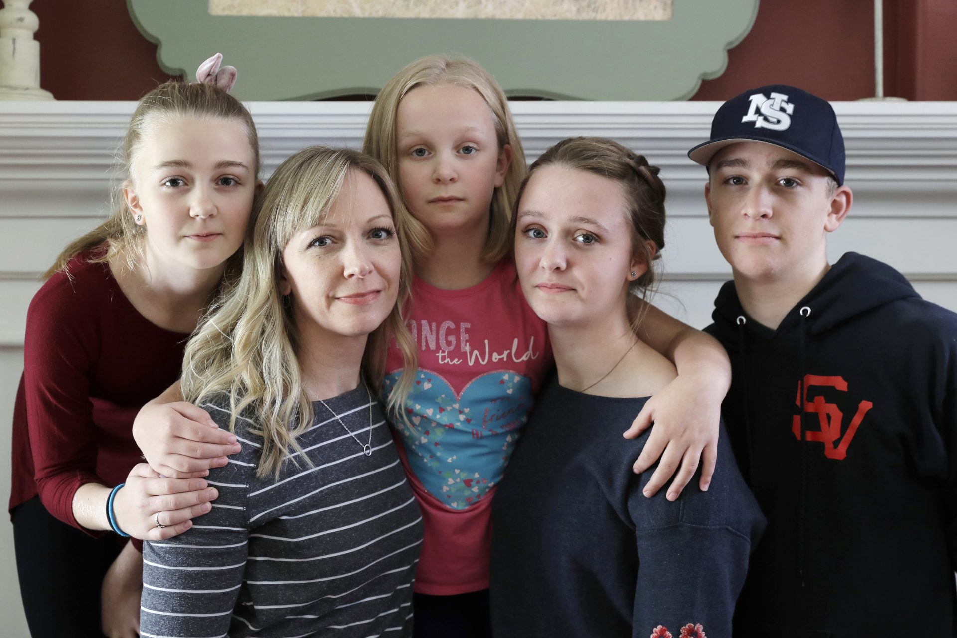 In this Oct. 9, 2019, photo, Donya Grant, second from left, poses for a photo with her children, Rowyn, 11, left, Mabry, 8, center, Hadley, 16, second from right, and Kemper, 14, right, in their home in Monroe, Wash. The family joined a lawsuit against the Monroe School District and others, alleging that the district failed to adequately respond to PCBs, or polychlorinated biphenyls, at the Sky Valley Education Center, a K-12 public school. Grant has homeschooled her children since they left Sky Valley in 2016 for health reasons that they believe were related to the toxic chemicals.