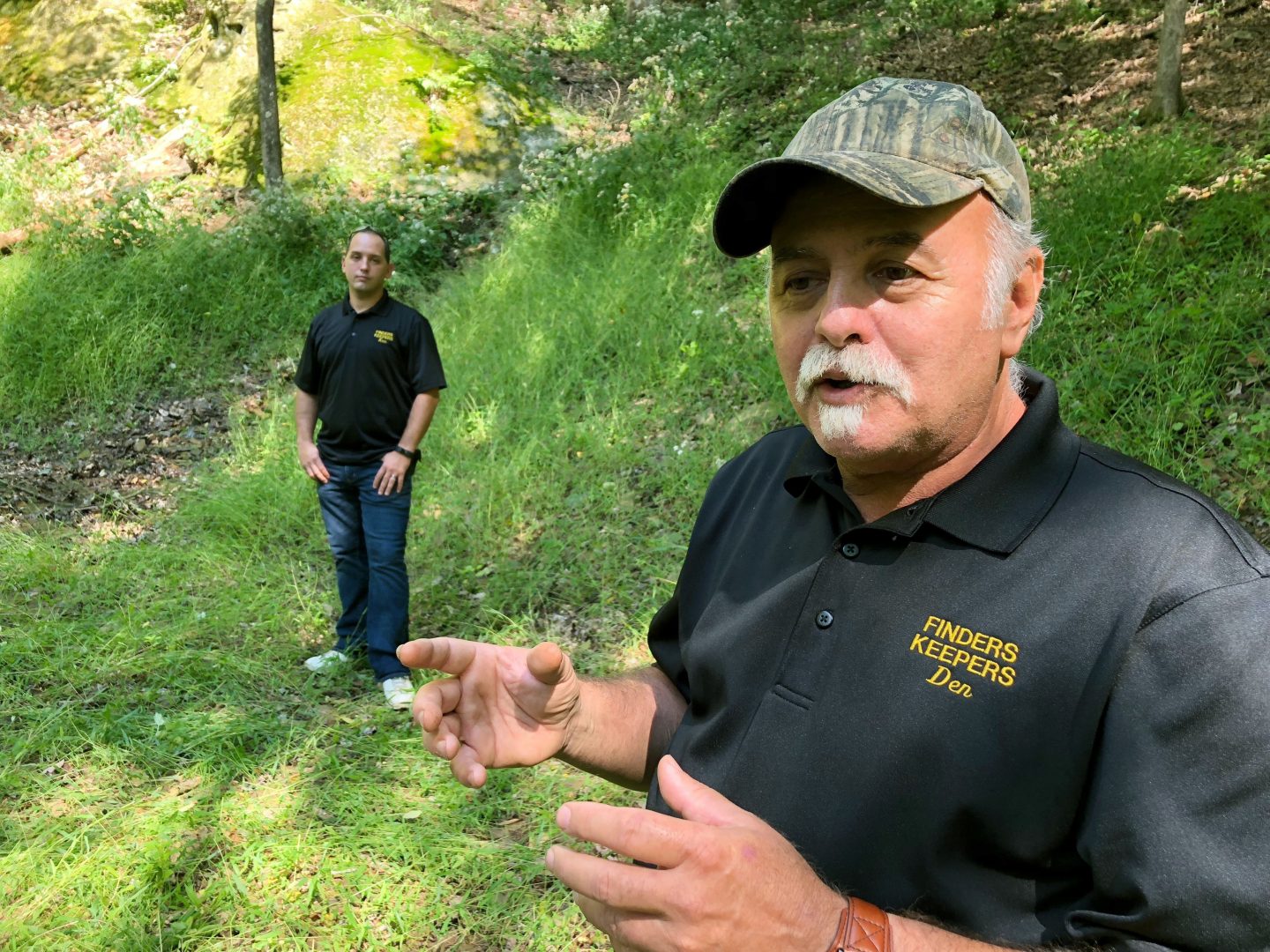 In this Sept. 20, 2018 photo, Dennis Parada, right, and his son Kem Parada stand at the site of the FBI's dig for Civil War-era gold in Dents Run, Pennsylvania. On Thursday, Oct. 24, 2019 an appeals court ordered Pennsylvania state officials to produce their communications with the FBI about the excavation, which was conducted on state-owned land. The state Department of Conservation and Natural Resources had refused to provide the documents to Finders Keepers, citing a federal court order.