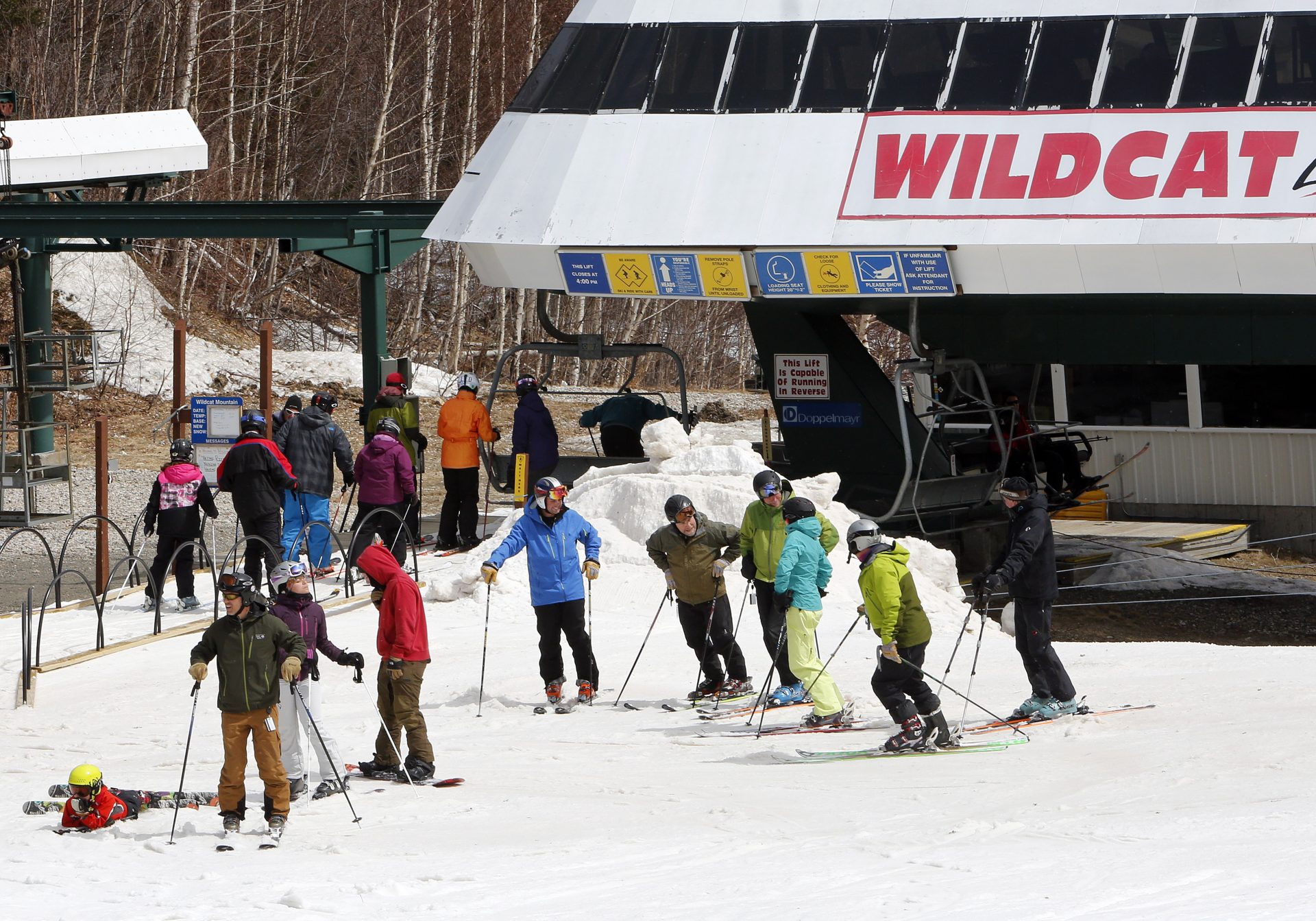 In this photo taken April 25, 2015, skiers gather at the chairlift at Wildcat ski area in Gorham, N.H. Wildcat is one of the 17 Peak Resorts locations sold to Vail Resorts.