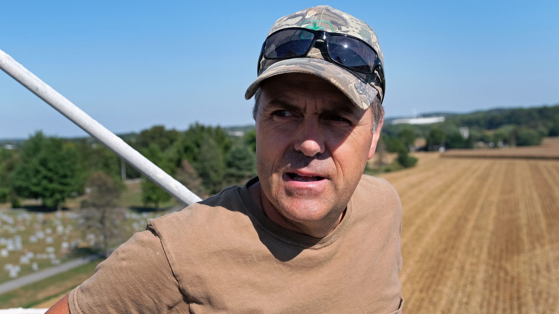 Grain farmer Don Cairns looks out over land he farms while atop a grain silo Sept. 25, 2019, at Cairns Family Farm in Sadsbury Township, Pennsylvania.