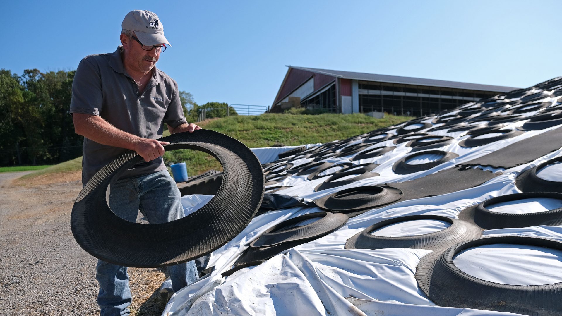 Dairy farmer Duane Hershey covers a pile of bedding for cows converted from cow waste and filtered and converted in an effort to reuse materials Sept. 25, 2019, at Ar-Joy Farms in West Fallowfield Township, Pennsylvania.