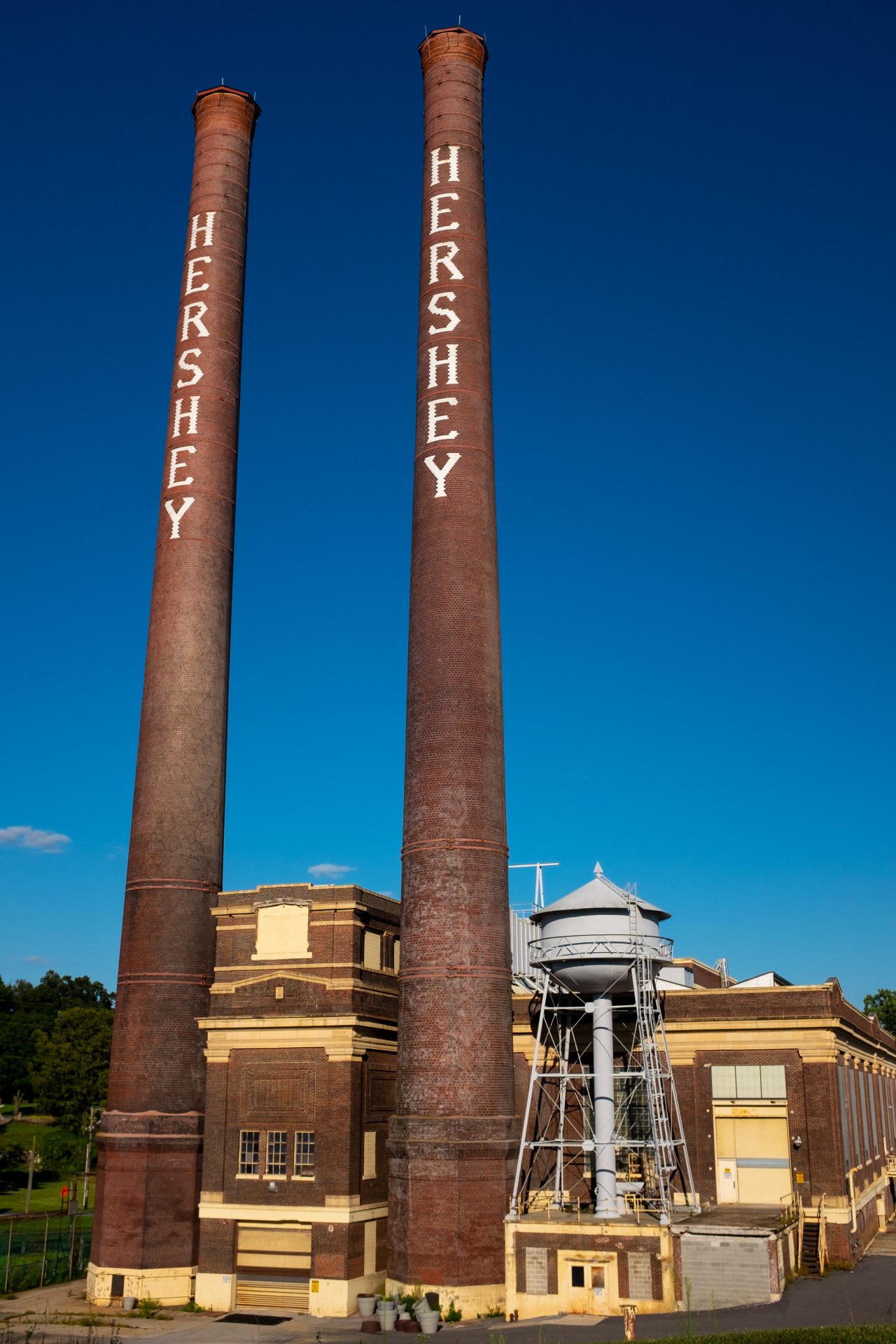 Two smokestacks stand at the old Hershey factory in Hershey, Pa., in September 2019.