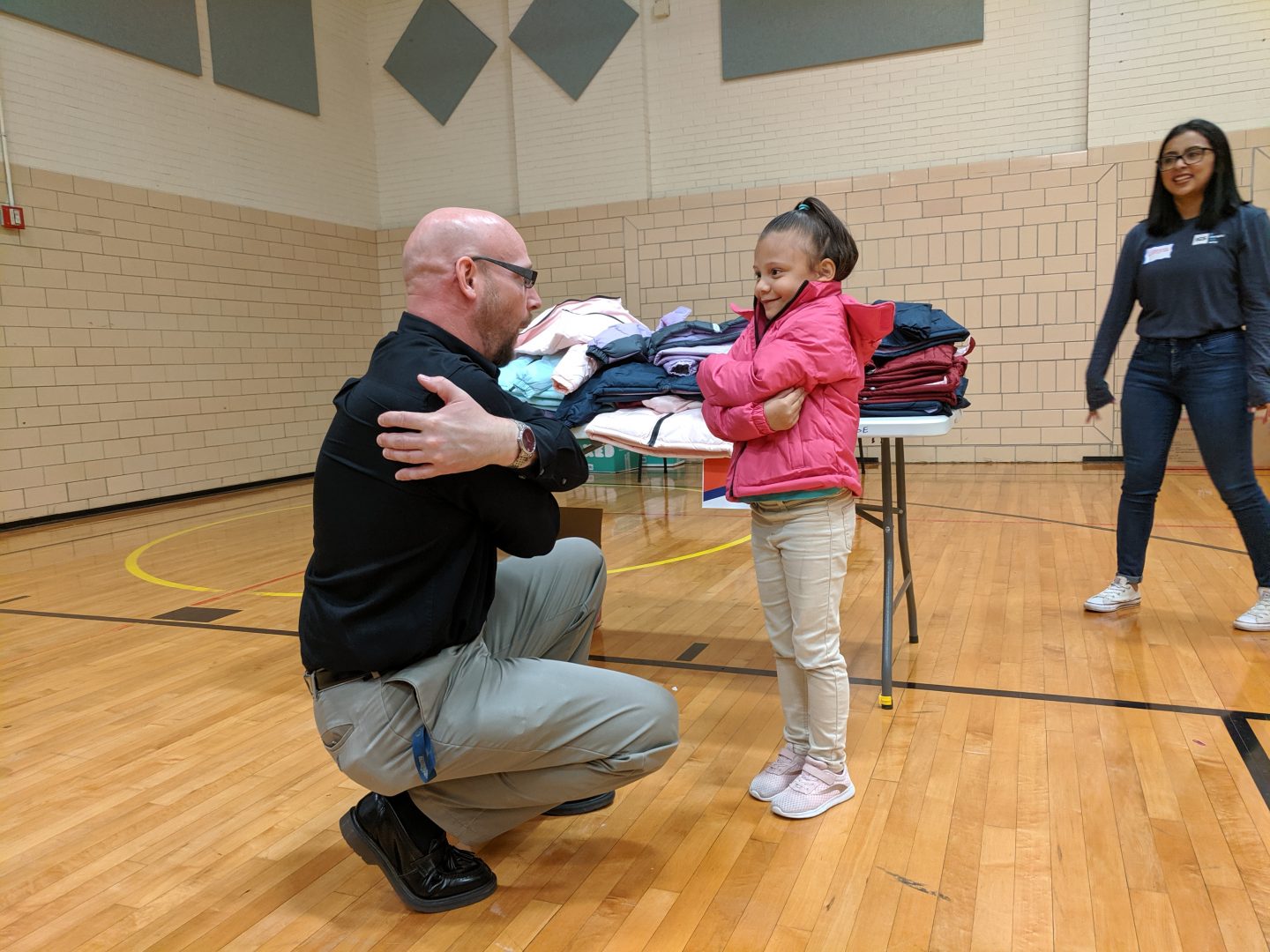 A volunteer from IGS Energy fits a Foose Elementary School student with a new winter coat in Harrisburg on Wednesday, October 9th, 2019. More than 500 coats were donated through the nonprofit Operation Warm. 