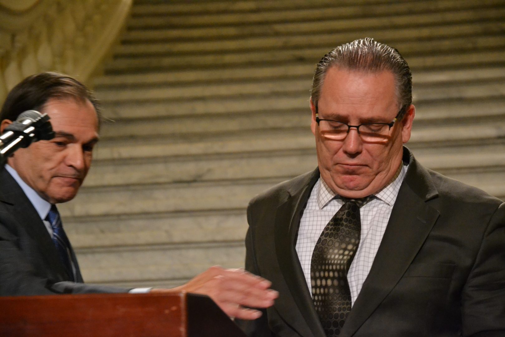 Patrick Duggan leaves the podium after talking to reporters at the Capitol rotunda Thurs., Oct. 10, 2019. Duggan says he was sexually abused by his history teacher at St. Francis of Assisi Catholic School in Harrisburg in the mid-to late 1970s, when Duggan was a teenager. At left is his attorney, Richard Serbin.