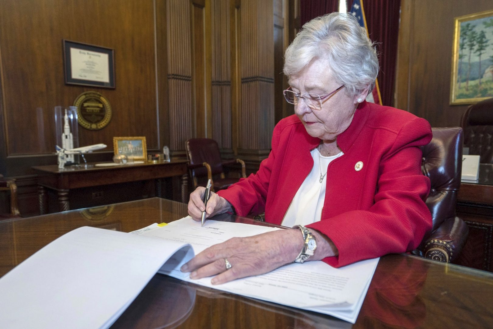 FILE PHOTO: In this Wednesday, May 15, 2019 file photo released by the state shows Alabama Gov. Kay Ivey signing a bill that virtually outlaws abortion in the state, in Montgomery, Ala. U.S. District Judge Myron Thompson on Tuesday, Oct. 29, 2019, has blocked an Alabama abortion ban that would have made the procedure a felony at any stage of pregnancy in almost all cases. 