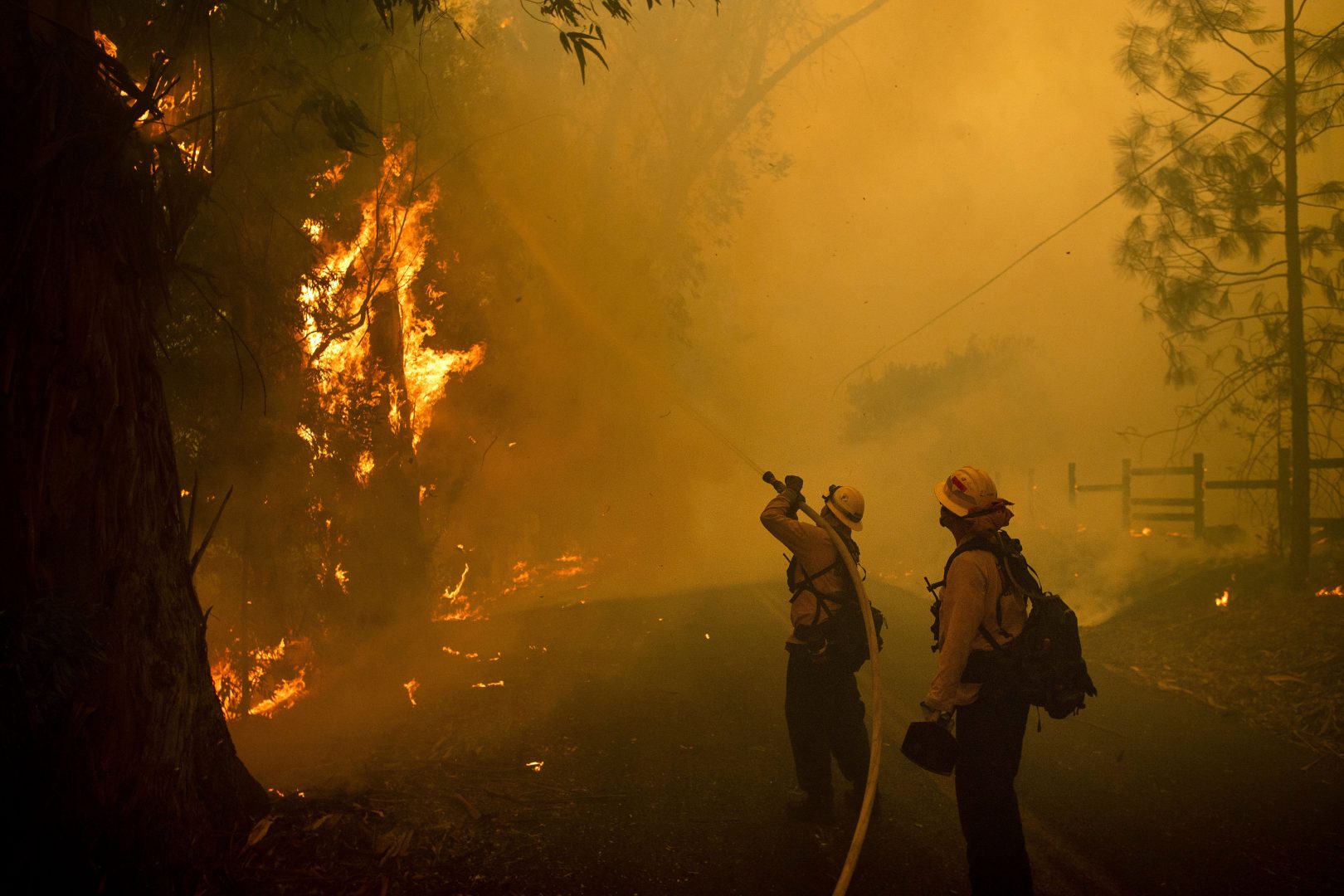 Firefighters battle a wildfire called the Kincade Fire on Chalk Hill Road in Healdsburg, Calif., Sunday, Oct. 27, 2019.