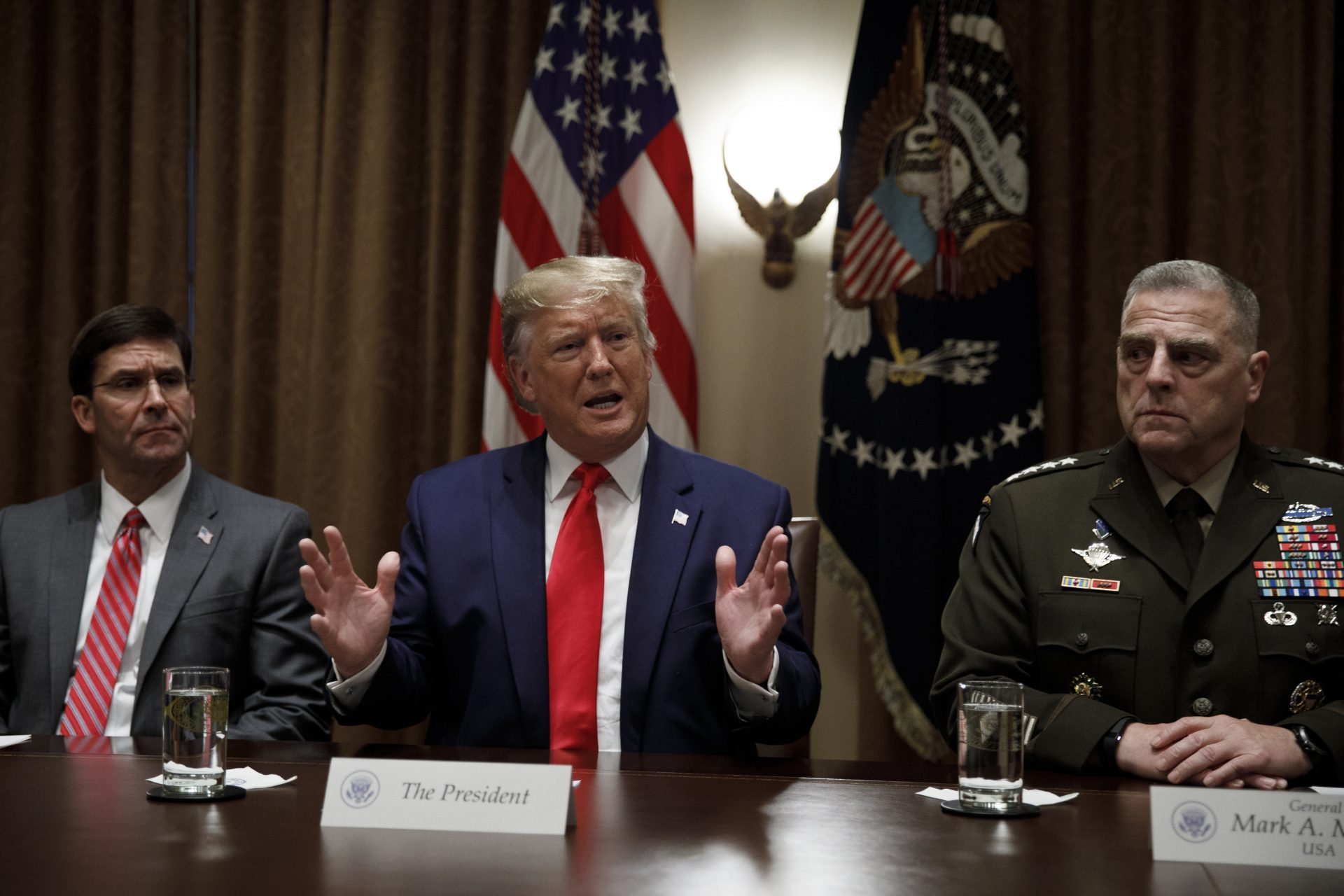 President Donald Trump, joined by from left, Defense Secretary Mark Esper, and Chairman of the Joint Chiefs of Staff Gen. Mark Milley, speaks to media during a briefing with senior military leaders in the Cabinet Room at the White House in Washington, Monday, Oct. 7, 2019.