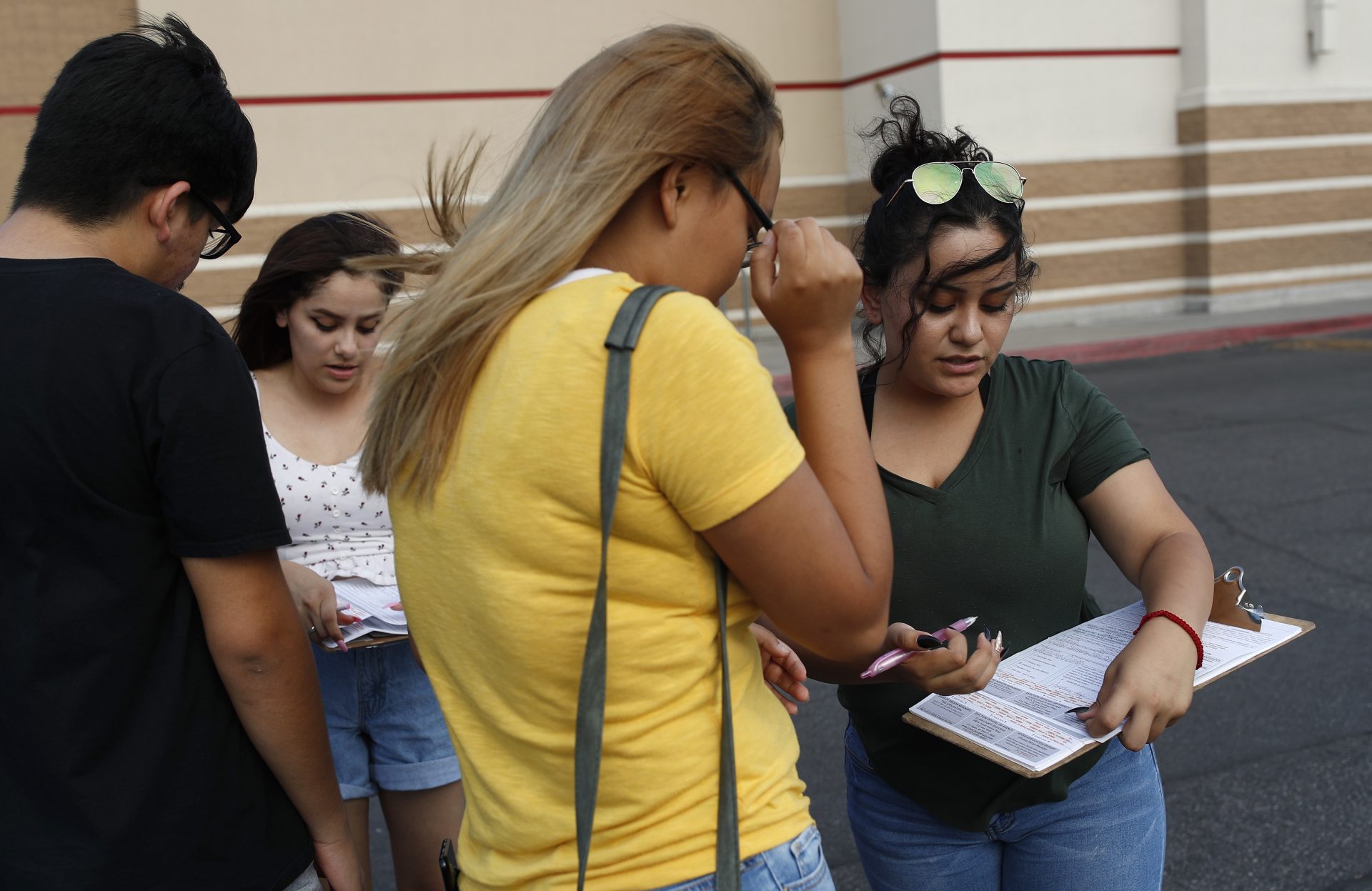 FILE PHOTO: Maria Nieto, right, and Alma Romo, second from left, register people to v