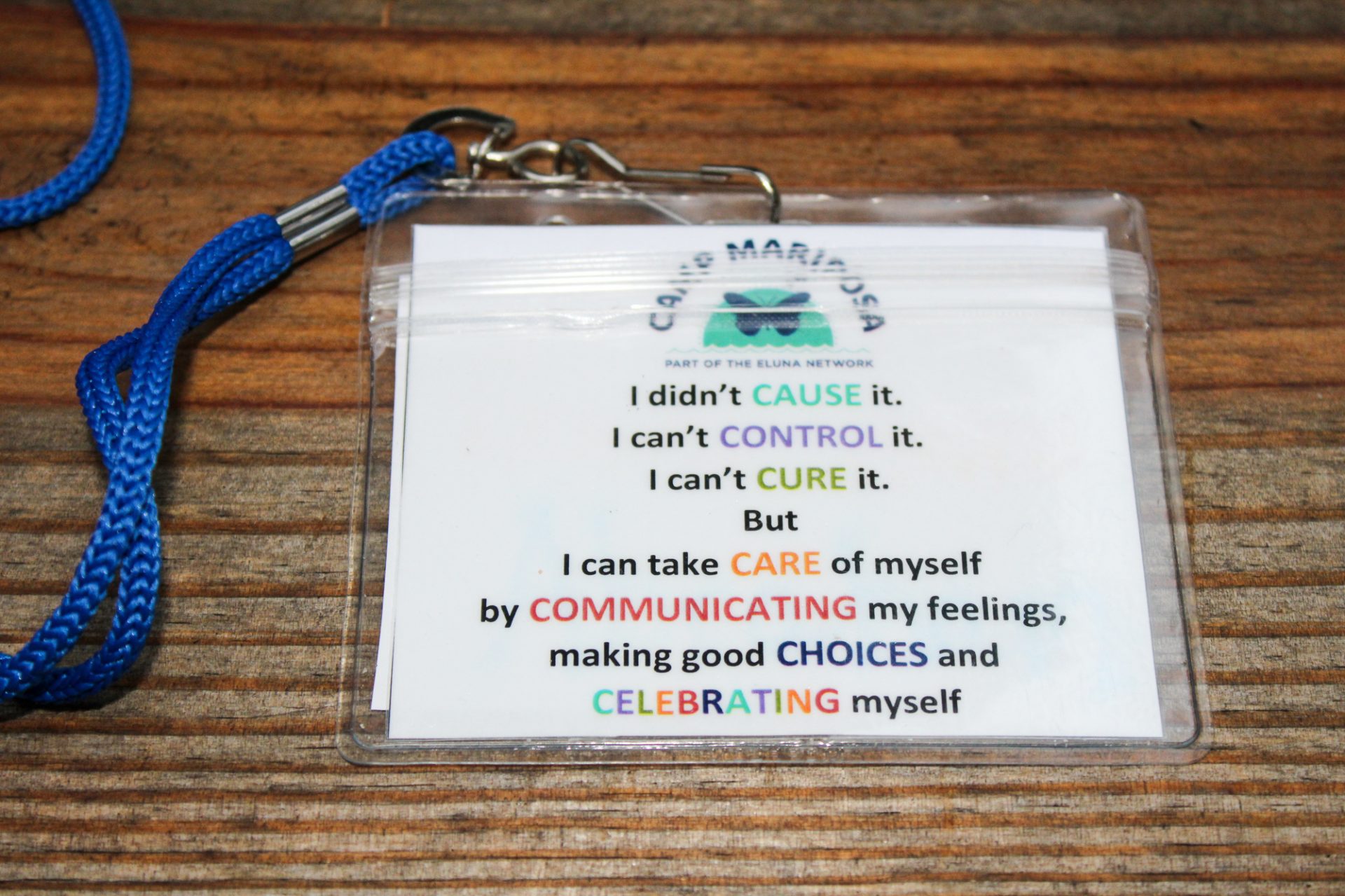 The lyrics of the Camp Mariposa song, "7 Cs," are printed out on lanyards so new campers can sing along. "It helps me realize that I didn't cause what happened to me," one child said. "It makes me feel much better."