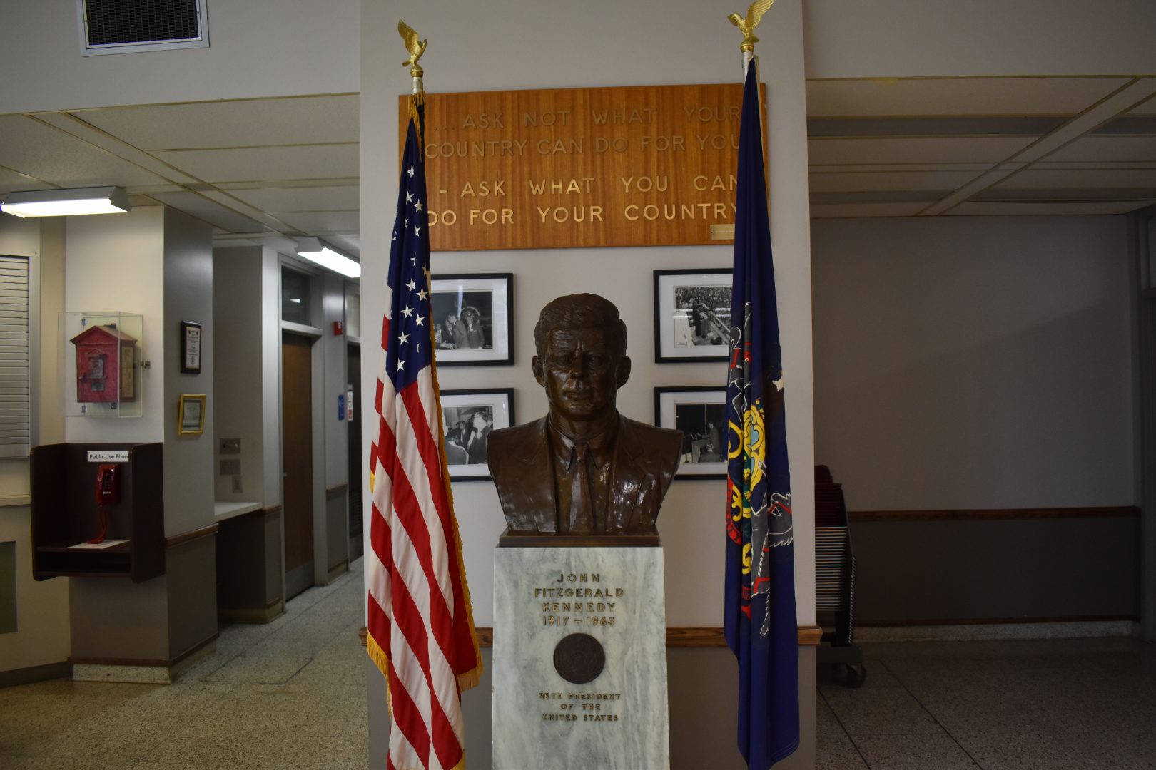 A tribute to President John F. Kennedy greets visitors at the entrance to Erie’s city hall on Sept. 12, 2019.
