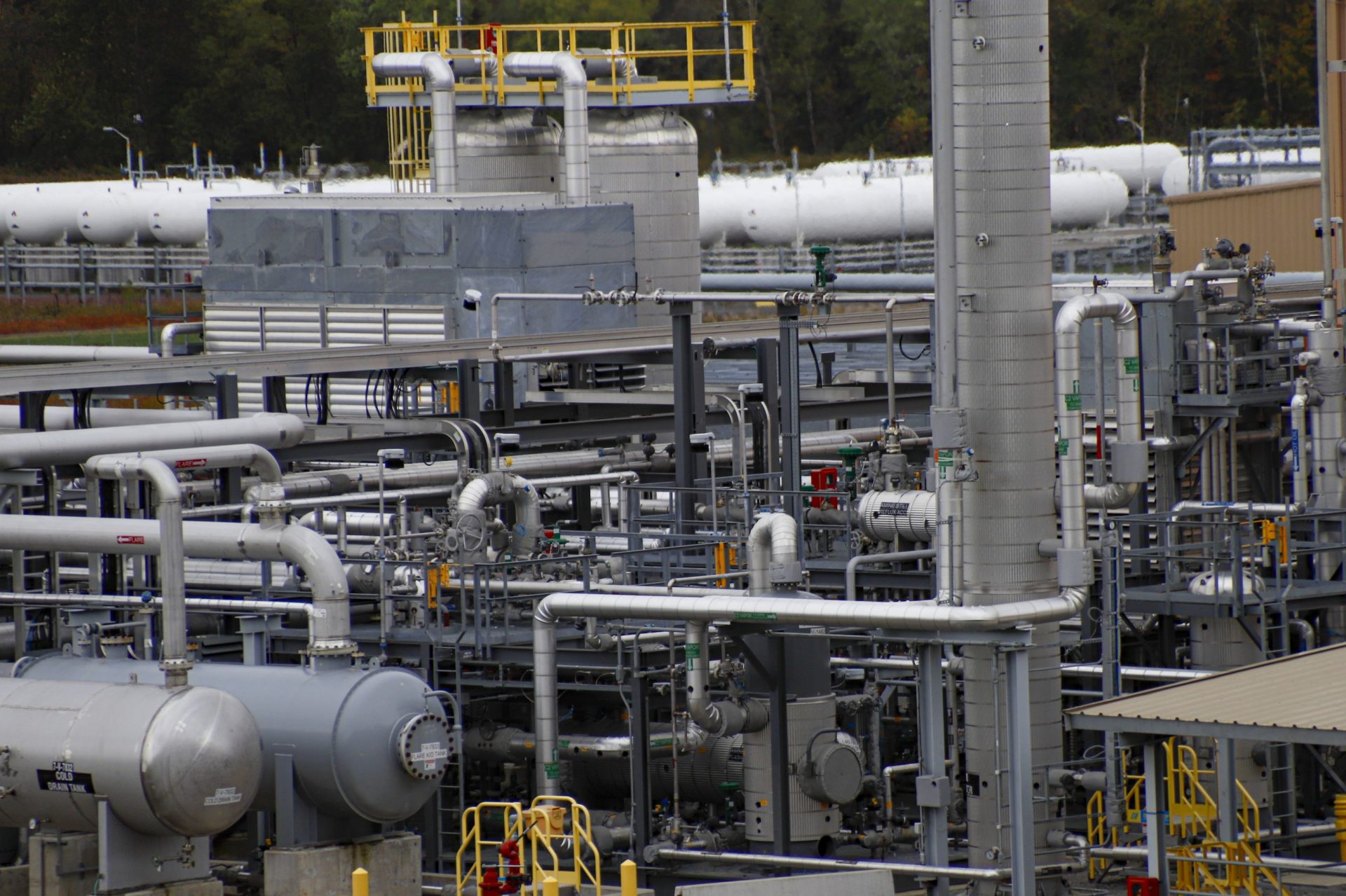 In this Oct. 17, 2019, photo, tanks and pipes move product through the MarkWest Bluestone Gas Processing Plant in Evans City, Pa. President Donald Trump has aligned with Pennsylvania's natural gas industry, but his support for the industry in the nation's No. 2 natural gas state may not yield the expected political boost in what is perhaps the nation's premier presidential battleground state. In parts of the state critical to his path to victory, opposition to fracking is growing and calls for getting tough on the industry are popular.