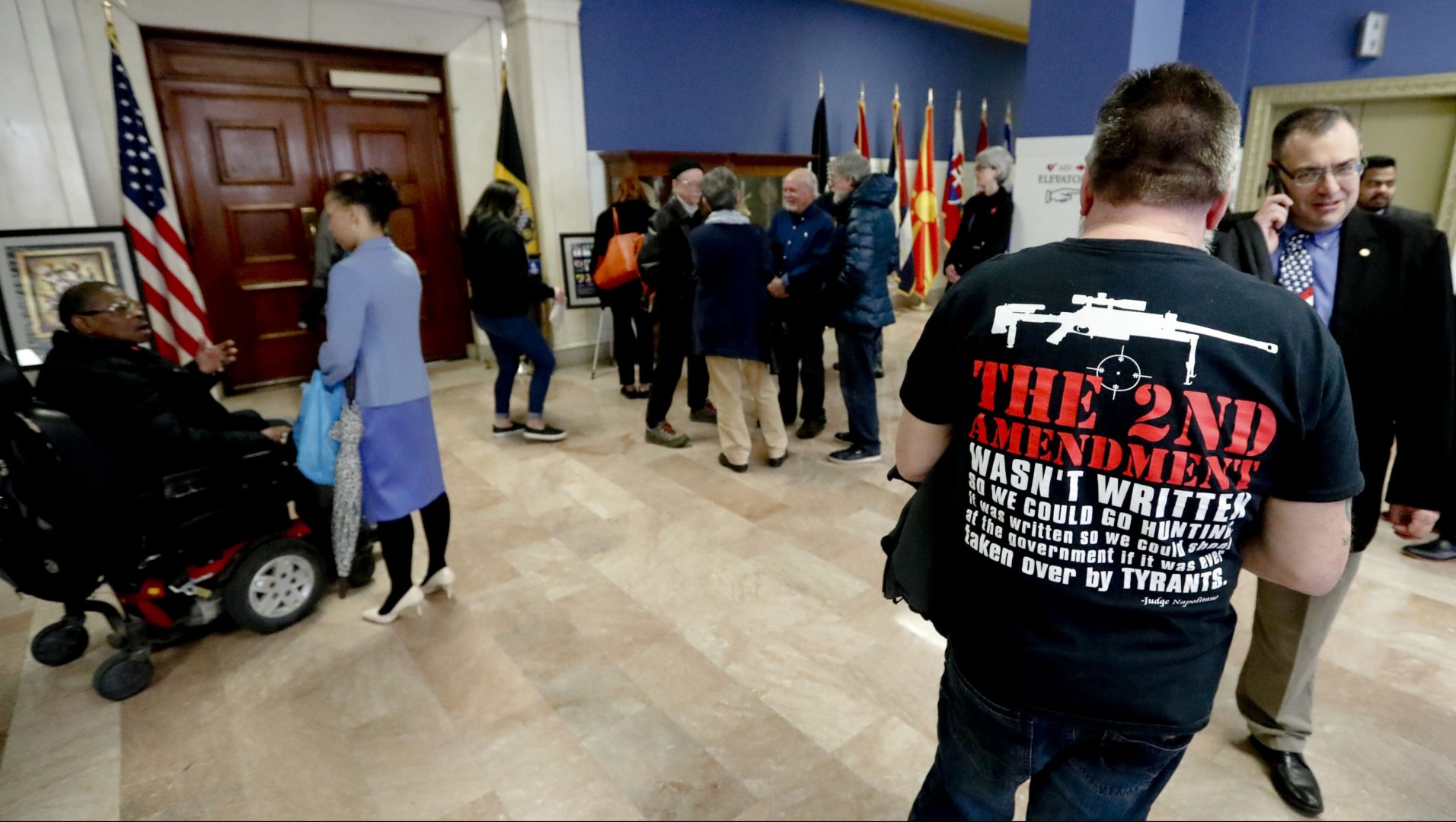 FILE PHOTO: Dennis Jordan, right, a Pittsburgh resident, wears a shirt supporting the 2nd Amendment as he waits with others to attend a Pittsburgh City Council meeting regarding proposed gun restriction legislation, Tuesday, April 2, 2019, in Pittsburgh.