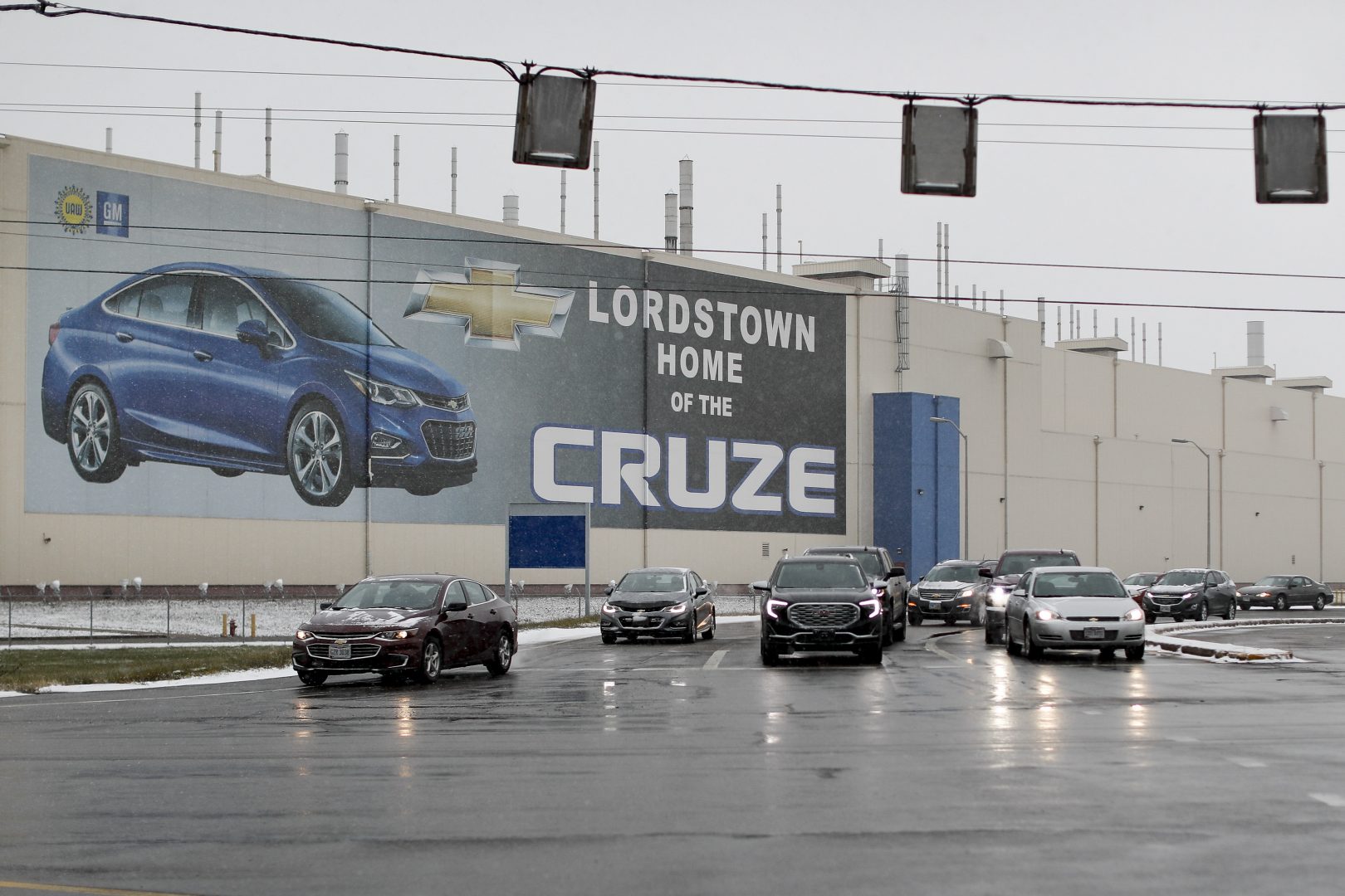 FILE PHOTO: In this Nov. 27, 2018, file photo a banner depicting the Chevrolet Cruze model vehicle is displayed at the General Motors' Lordstown plant in Lordstown, Ohio. An economic renaissance in the industrial Midwest promised by President Donald Trump has suffered in recent weeks in ways that could be problematic for Trump's 2020 re-election. 