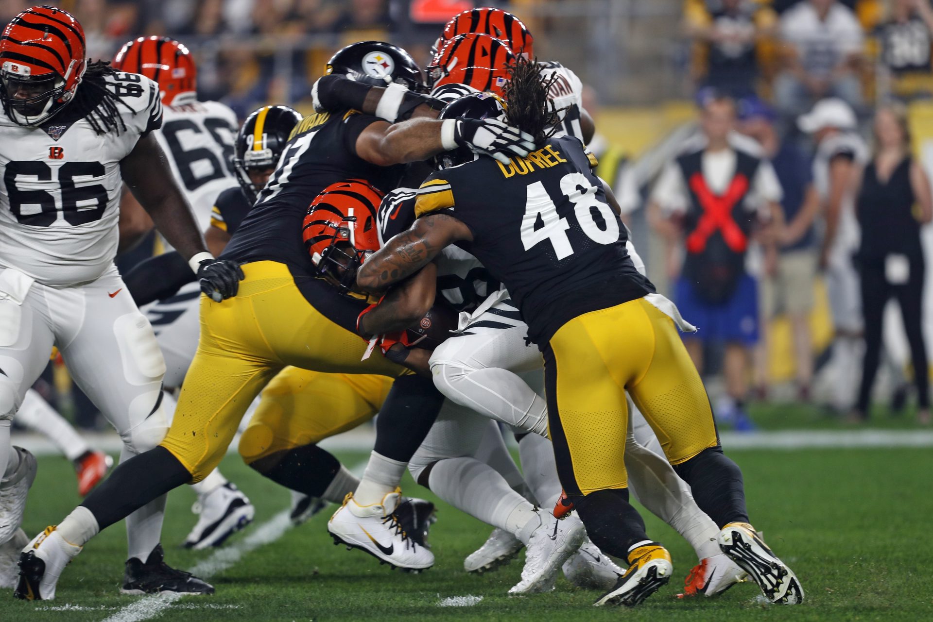 Cincinnati Bengals running back Joe Mixon, center, is tackled by Pittsburgh Steelers defensive end Cameron Heyward, left, and outside linebacker Bud Dupree (48) during the first half of an NFL football game in Pittsburgh, Monday, Sept. 30, 2019.