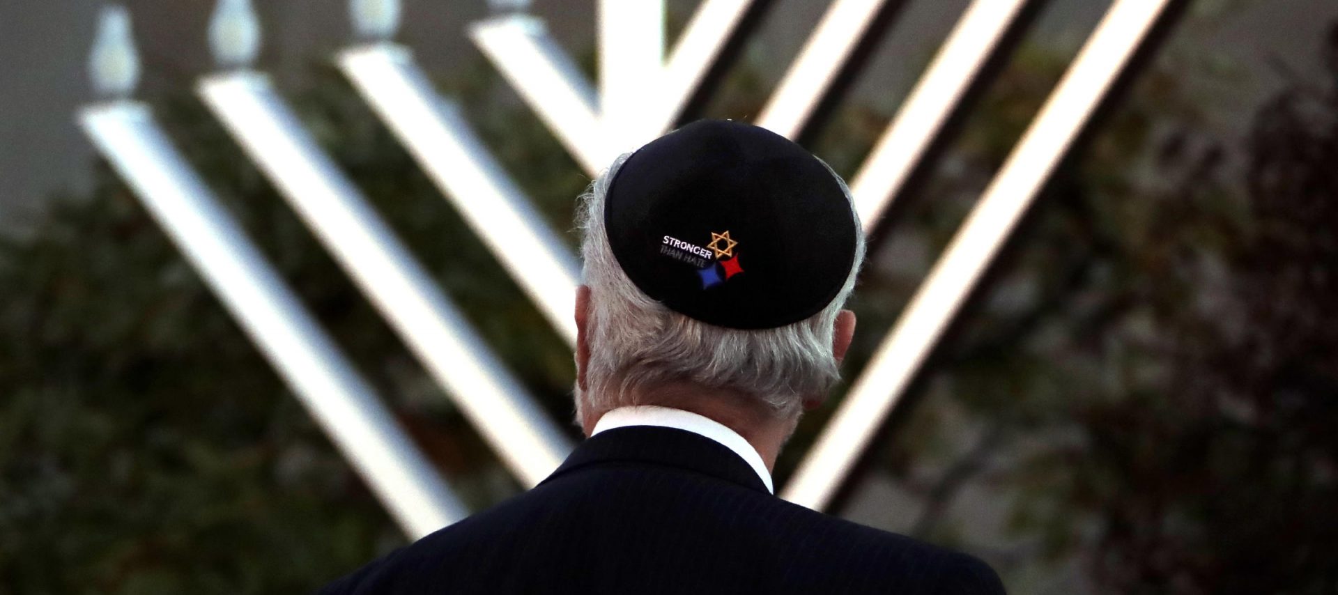 Rabbi Jeffrey Myers watches the installation of a menorah outside the Tree of Life Synagogue before holding a celebration on the first night of Hanukkah, Sunday, Dec. 2, 2018, in the Squirrel Hill neighborhood of Pittsburgh. A gunman shot and killed 11 people while they worshipped Saturday, Oct. 27, at the temple.