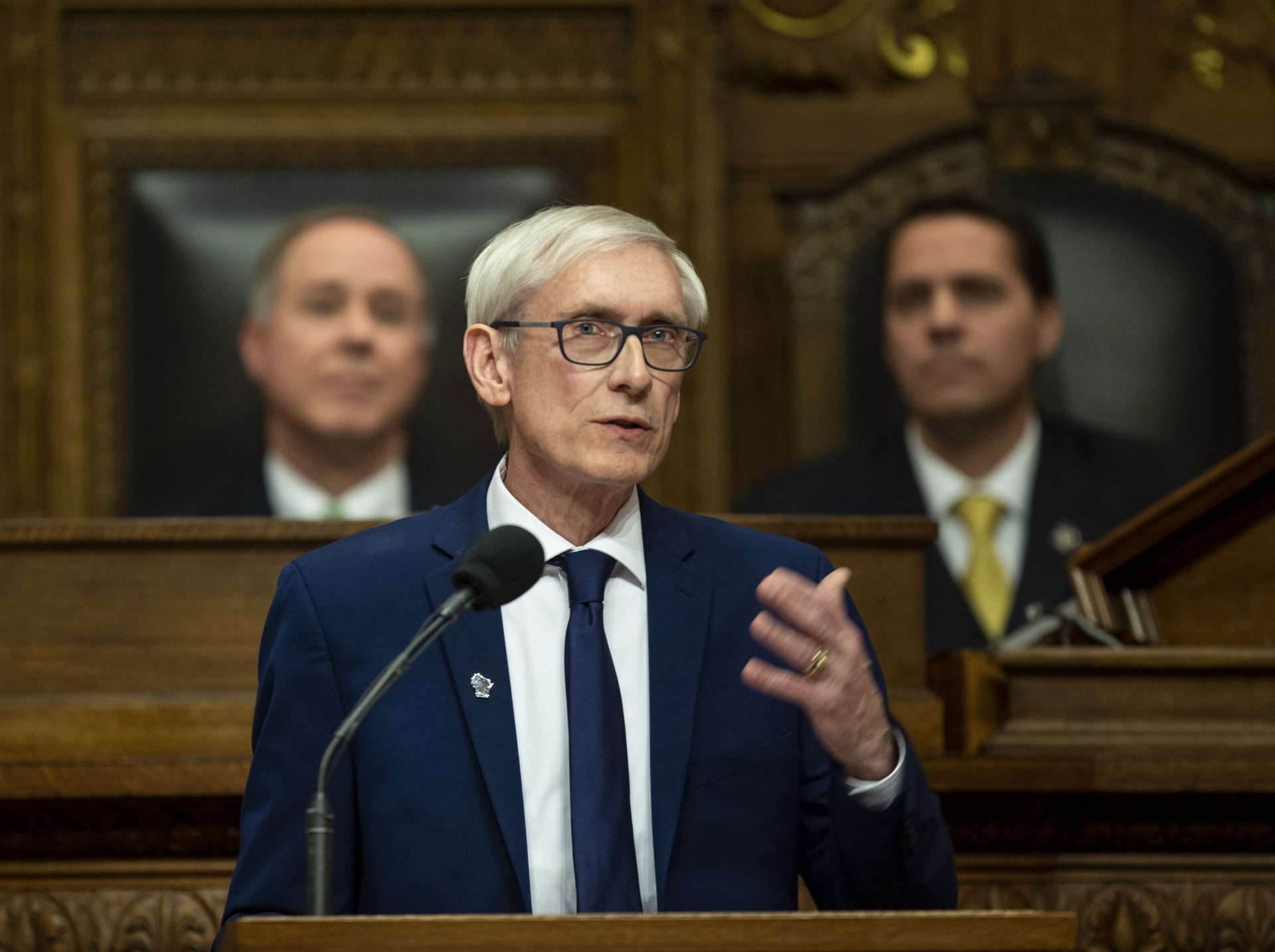 FILE PHOTO: In this Jan. 22, 2019 file photo, Wisconsin Gov. Tony Evers addresses a joint session of the Legislature in the Assembly chambers during the Governor's State of the State speech at the state Capitol, in Madison, Wis. Behind Evers is Assembly Speaker Robin Vos, R-Rochester, left, and Senate President Roger Roth, R-Appleton. Evers tried for months for the Legislature to take up gun control bills to no avail. So he recently called a special session to force them to convene on the issue.