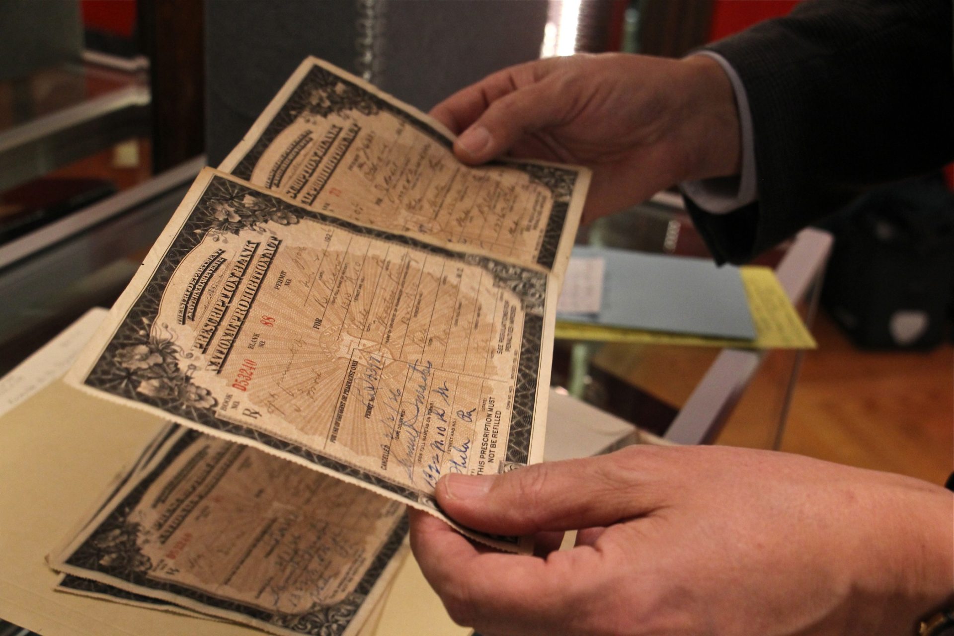 Historian Greg Higby looks through Prohibition Era prescriptions for whiskey in the University of Sciences collection.