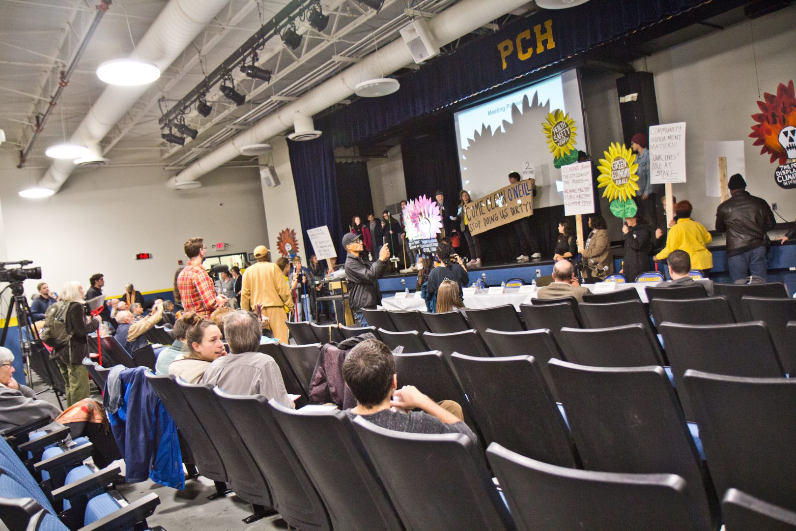 Members of the environmental group Philly Thrive took over a meeting about the legacy of clean-up at the PES Refinery. 