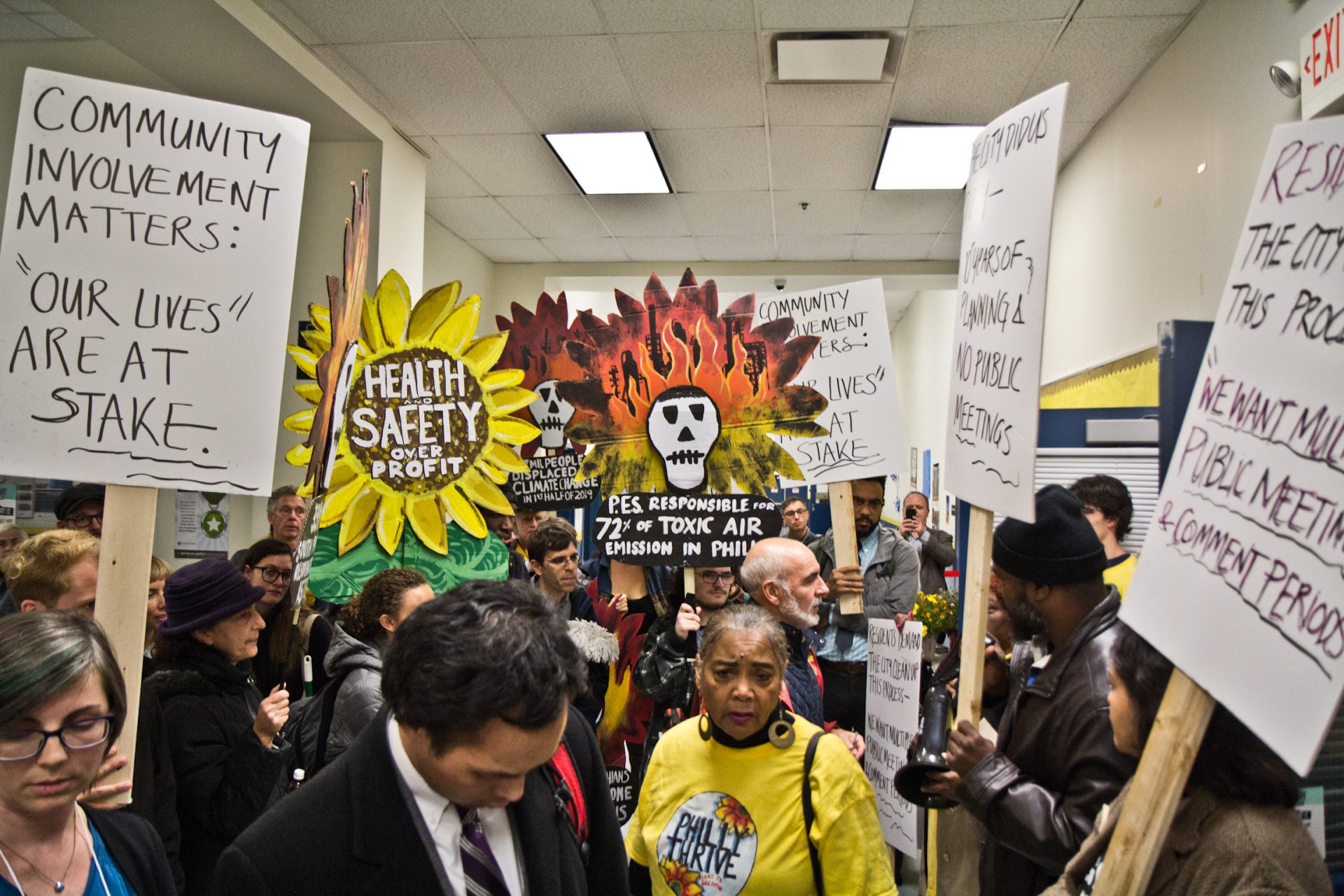 Members of the environmental group Philly Thrive protest a public meeting that did not put any residents on the panel. (Kimberly Paynter/WHYY)