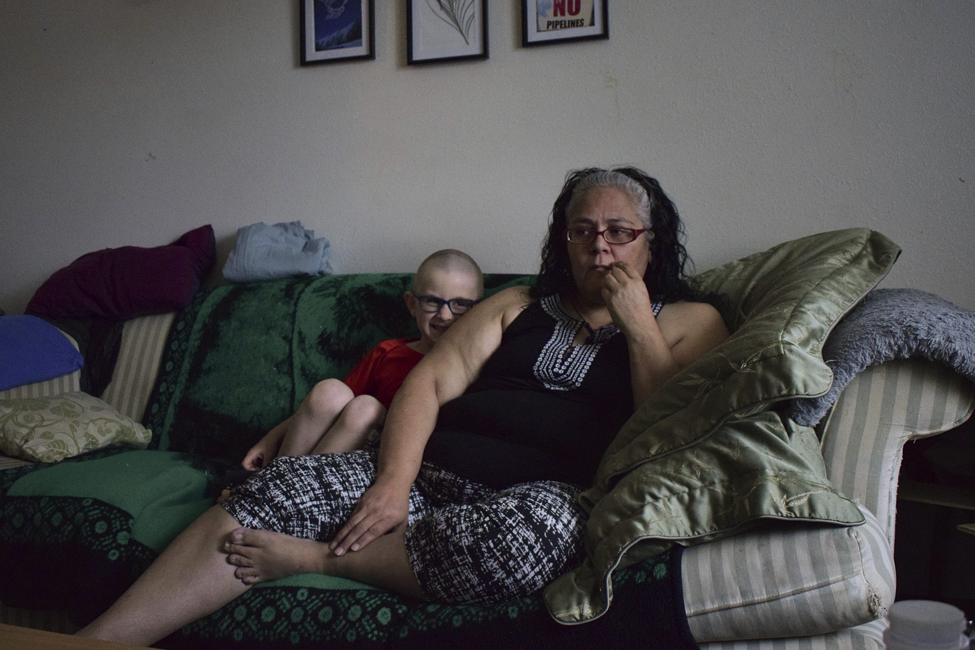 Leona Peterson and her son, Wayne, 6, sit in their home in Prince Rupert, British Columbia, Canada. When Peterson moved into the subsidized Indigenous housing complex with her family, a neighbor warned her about the poor quality of the drinking water.