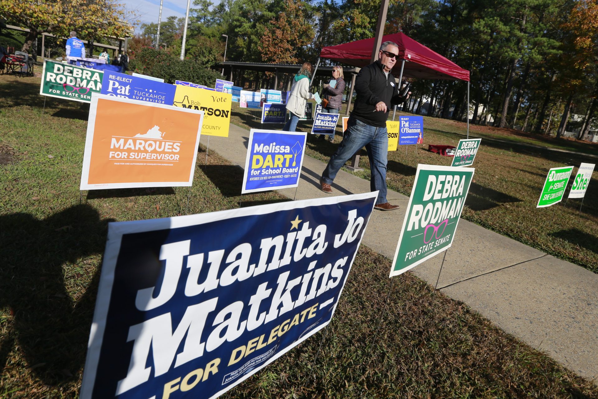 Voters walk through a sea of campaign signs at a polling station in Richmond, Va., Tuesday, Nov. 5, 2019. All seats in the Virginia House of Delegates and State senate are up for election.