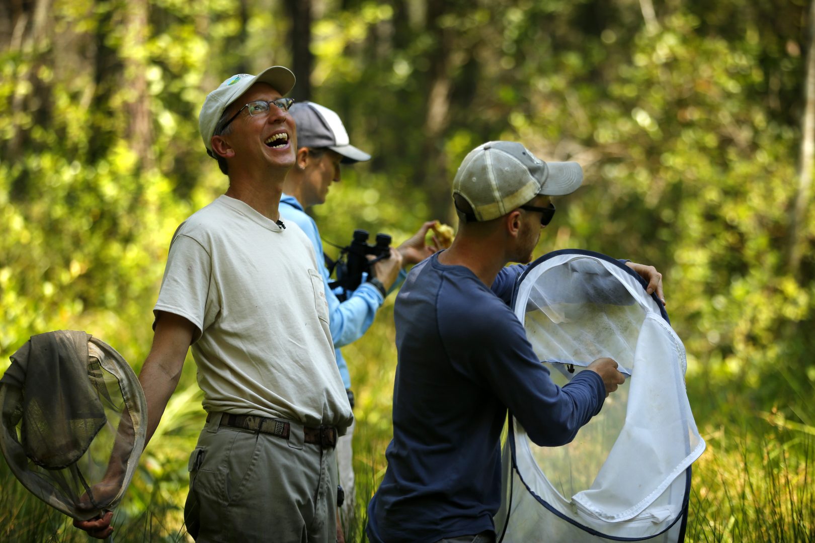 Nick Haddad, left, watches a captive-bred female St. Francis' satyr butterfly fly off after it was released into the wild at Fort Bragg in North Carolina on Monday, July 29, 2019. Haddad has been studying the rare butterfly for more than 15 years.