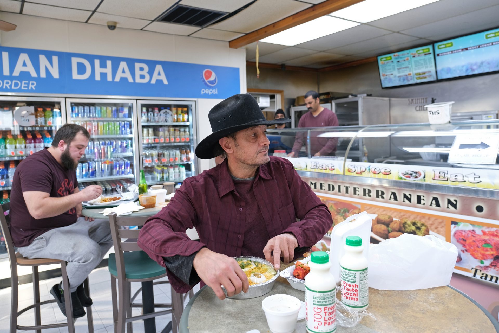 Sean Yazici, of Indiana, opens his food while inside Eat Spice on Oct. 24, 2019, in the truck stop on route 534 off I-80 in White Haven, Pennsylvania. The restaurant caters to members of the Sikh community and as there is a large population of truckers from that community, the Indian Dhaba and Mediterranean dishes become hard to find on the road.