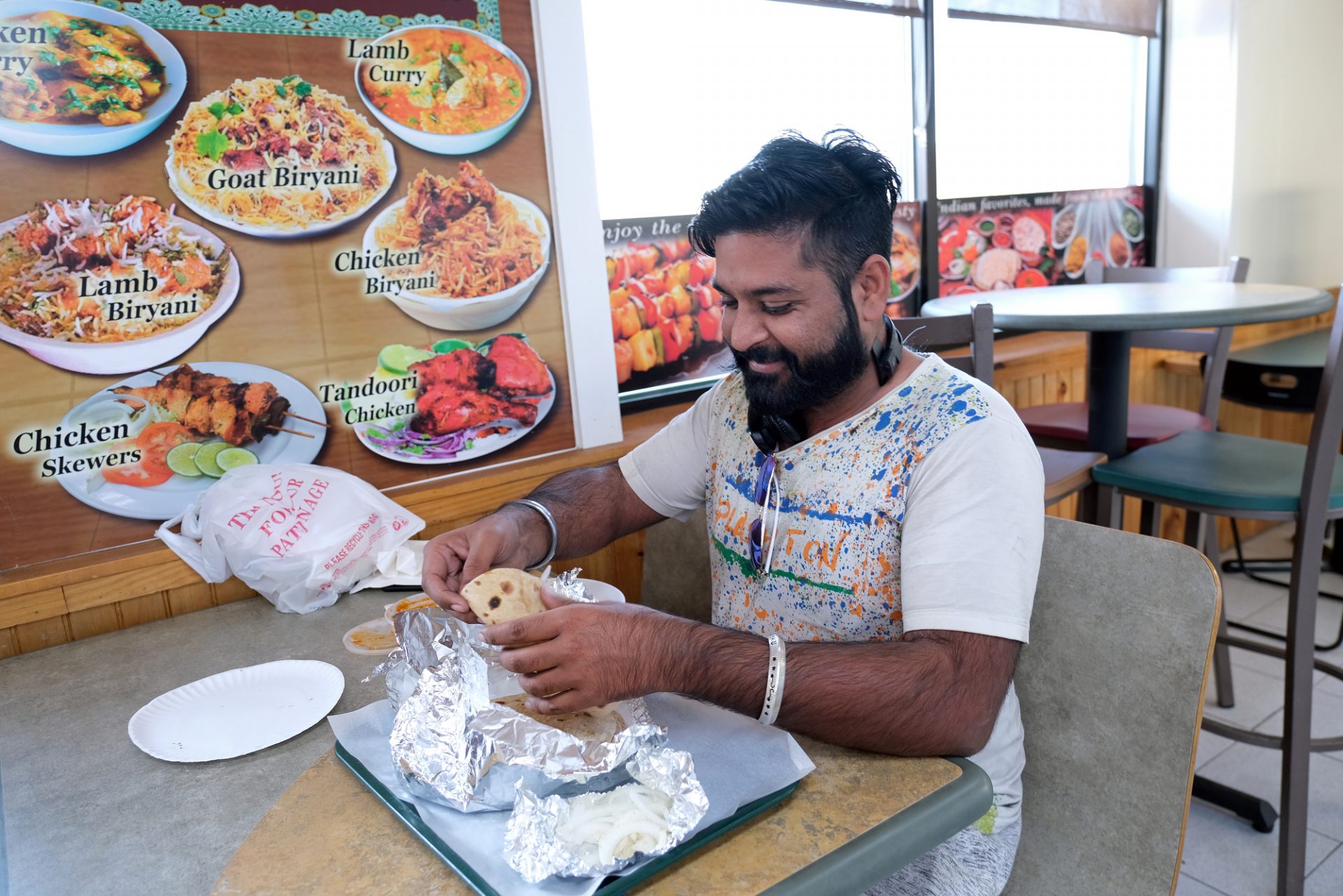 Aman Singh, of Indiana, talks while eating a meal at Eat Spice on Oct. 24, 2019, in the truck stop on route 534 off I-80 in White Haven, Pennsylvania. The restaurant caters to members of the Sikh community and as there is a large population of truckers from that community, the Indian Dhaba and Mediterranean dishes become hard to find on the road.