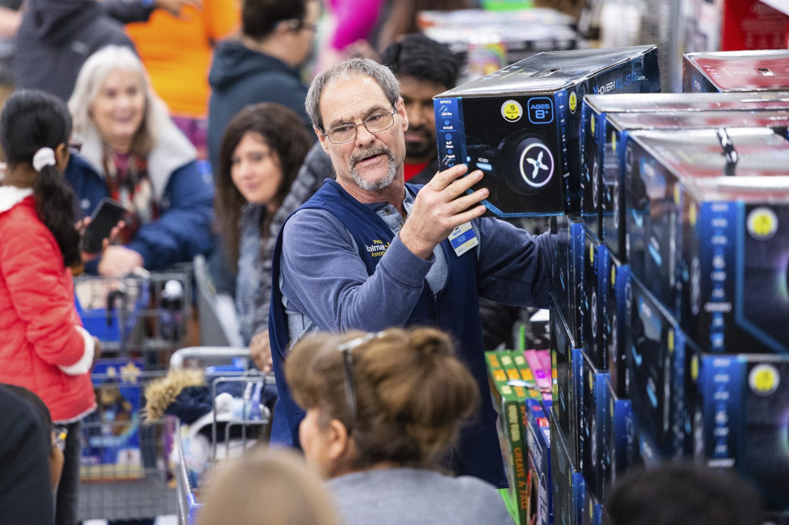 IMAGE DISTRIBUTED FOR WALMART - Walmart associate helps customers shop Black Friday deals at the retailer's store event, on Thursday Nov. 28, in Bentonville, Ark. (Gunnar Rathbun/AP Images for Walmart)