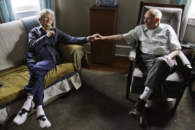 Alzheimer's patient Dorothy Eckert and her husband John Eckert's hold hands at their home in Norristown Pa., Thursday, April 19, 2007. Alzheimer's caregivers seldom can make time in their daily grind to seek out help. And when they do, they too often find waiting lists for services, or programs geared only toward people with advanced disease and not the larger pool in the purgatory that is dementia's decade-long middle ground between independence and helplessness.