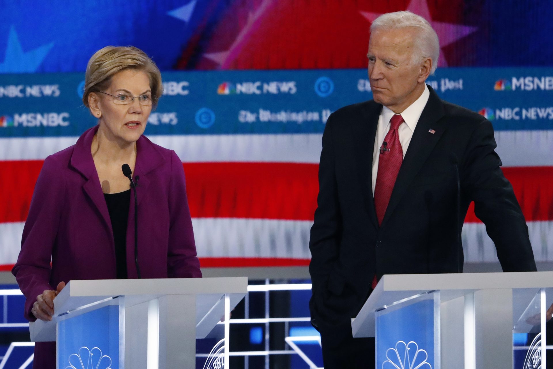 Democratic presidential candidate Sen. Elizabeth Warren, D-Mass., speaks as Democratic presidential candidate former Vice President Joe Biden listens during a Democratic presidential primary debate, Wednesday, Nov. 20, 2019, in Atlanta.