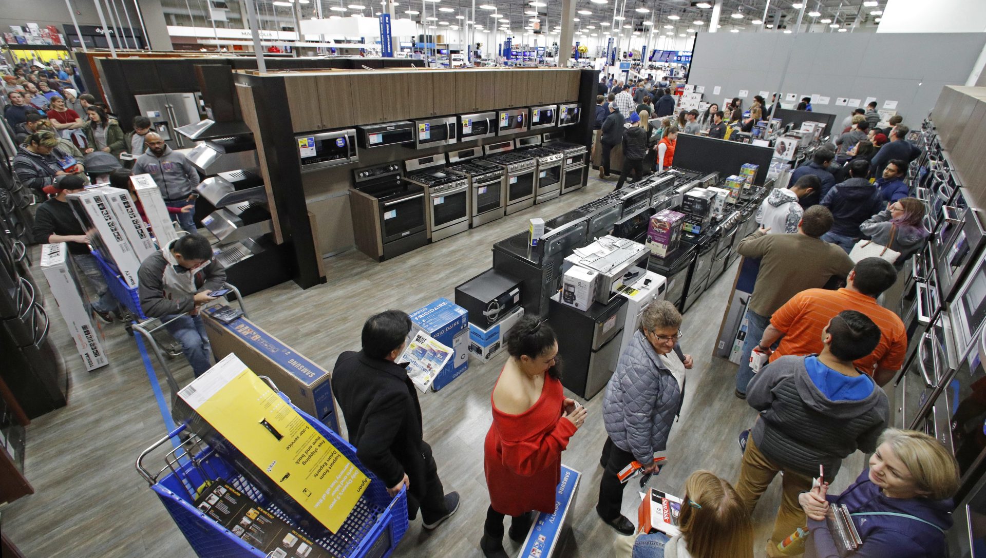 FILE PHOTO: In this Nov. 22, 2018, file photo people line up to pay for their purchases as they shop during an early Black Friday sale at a Best Buy store on Thanksgiving Day in Overland Park, Kan. Consumer spending rose a sharp 0.6 percent last month, the Commerce Department reported Thursday, Nov. 29.