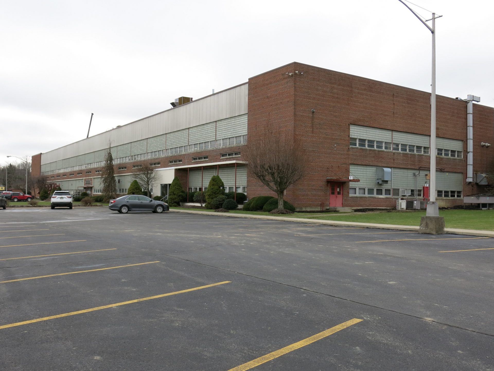 Just a few cars remain in the parking lot at the LEDVANCE factory. The company plans to decommission the plant by next summer.