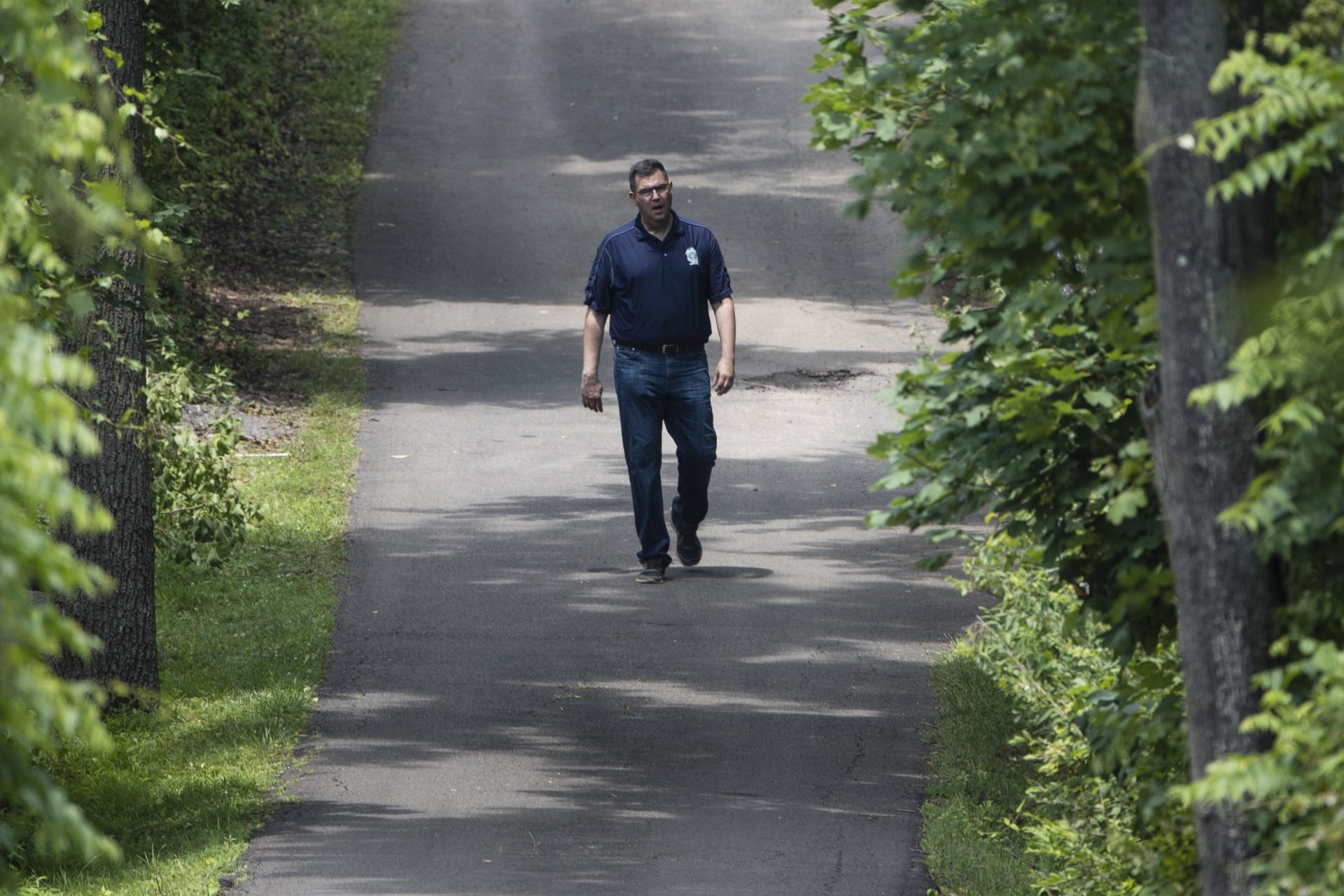 FILE PHOTO: Gregg Shore, First Assistant District Attorney for Bucks County, Pa., walks down a driveway, Wednesday, July 12, 2017, in Solebury, Pa., as the search continues for four missing young Pennsylvania men feared to be the victims of foul play.