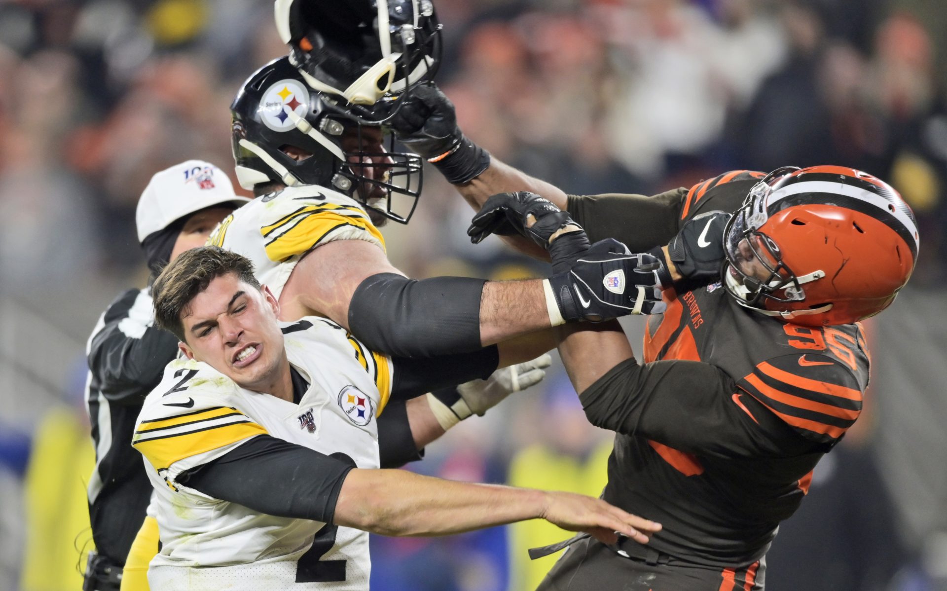 Cleveland Browns defensive end Myles Garrett (95) hits Pittsburgh Steelers quarterback Mason Rudolph (2) with a helmet during the second half of an NFL football game Thursday, Nov. 14, 2019, in Cleveland.