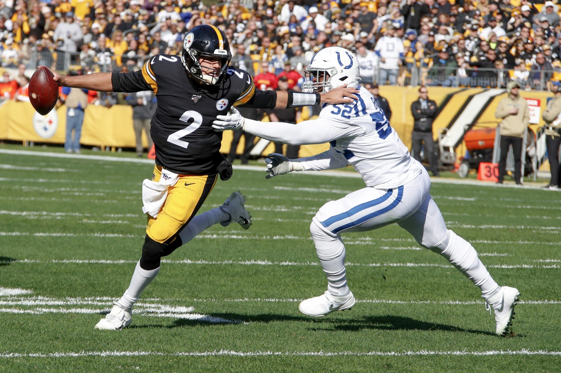 Pittsburgh Steelers quarterback Mason Rudolph (2) scrambles away from Indianapolis Colts defensive end Ben Banogu (52) in the first half of an NFL football game , Sunday, Nov. 3, 2019, in Pittsburgh.