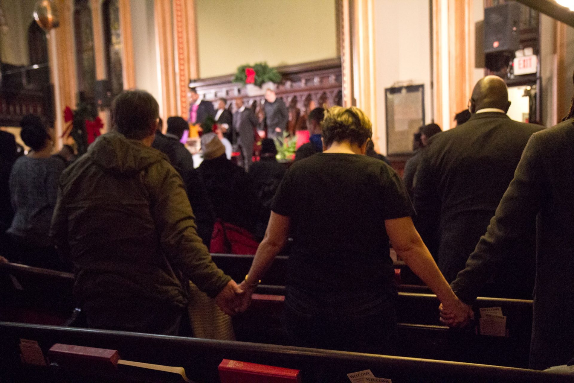 Attendees to a rally to reform the Philadelphia Police Department hold hands an pray for justice at the Arch Street United Methodist Church.
