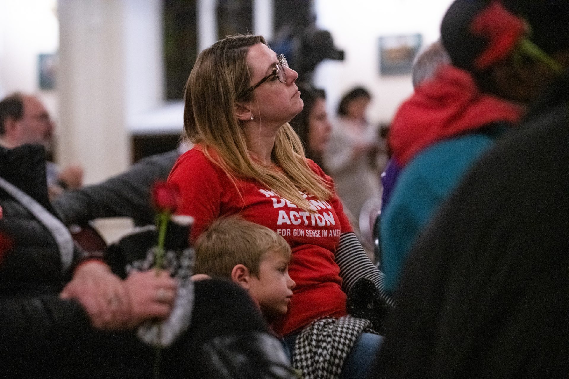 Joyce Pickles, a mother with Moms Demand Action, sits with her son Dominic, 6, during a vigil for gun violence victims at Broad Street Ministry on Wednesday, December 11, 2019.