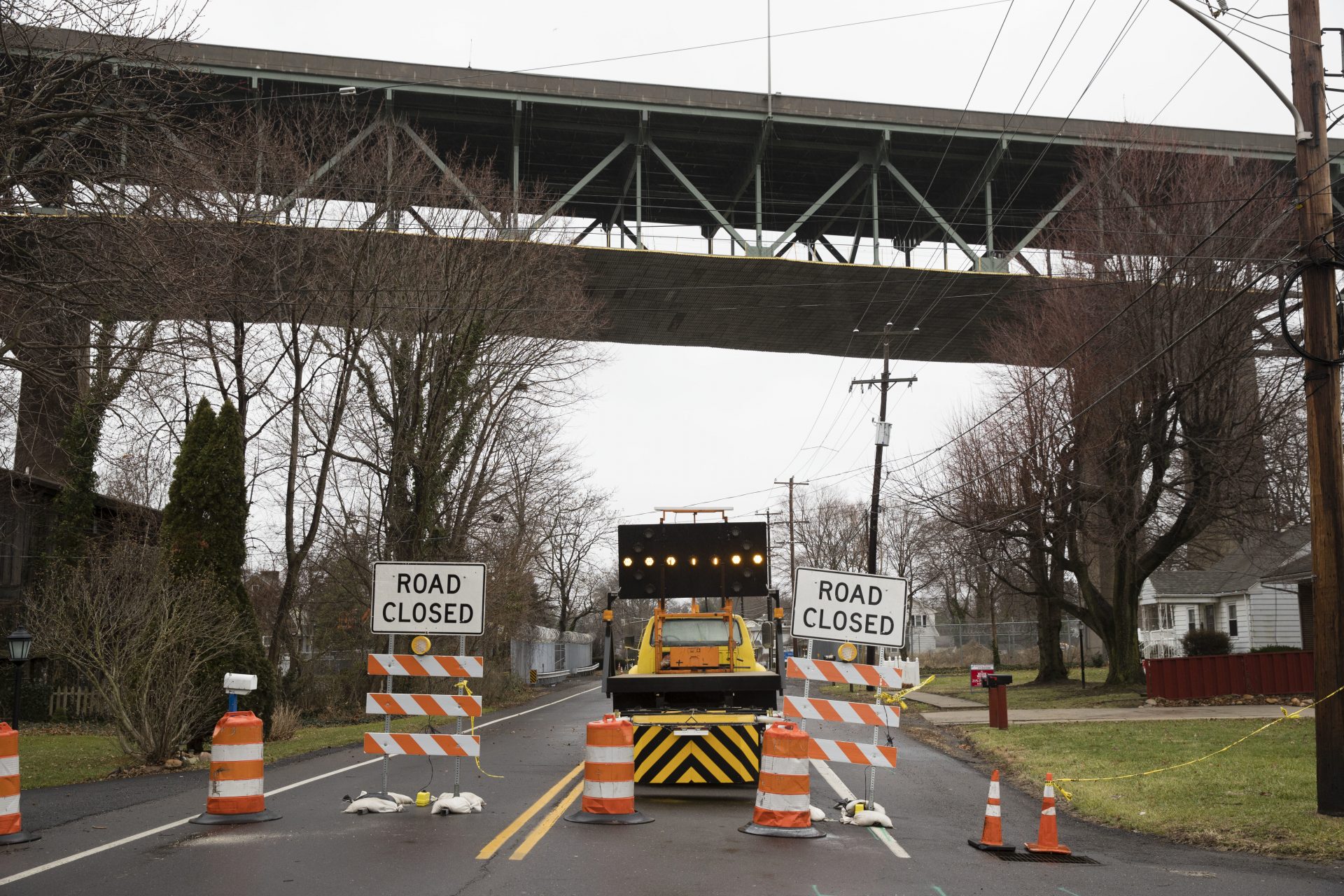 A road passing beneath the Delaware River Bridge is barricaded in Bristol, Pa., Monday, Jan. 23, 2017.