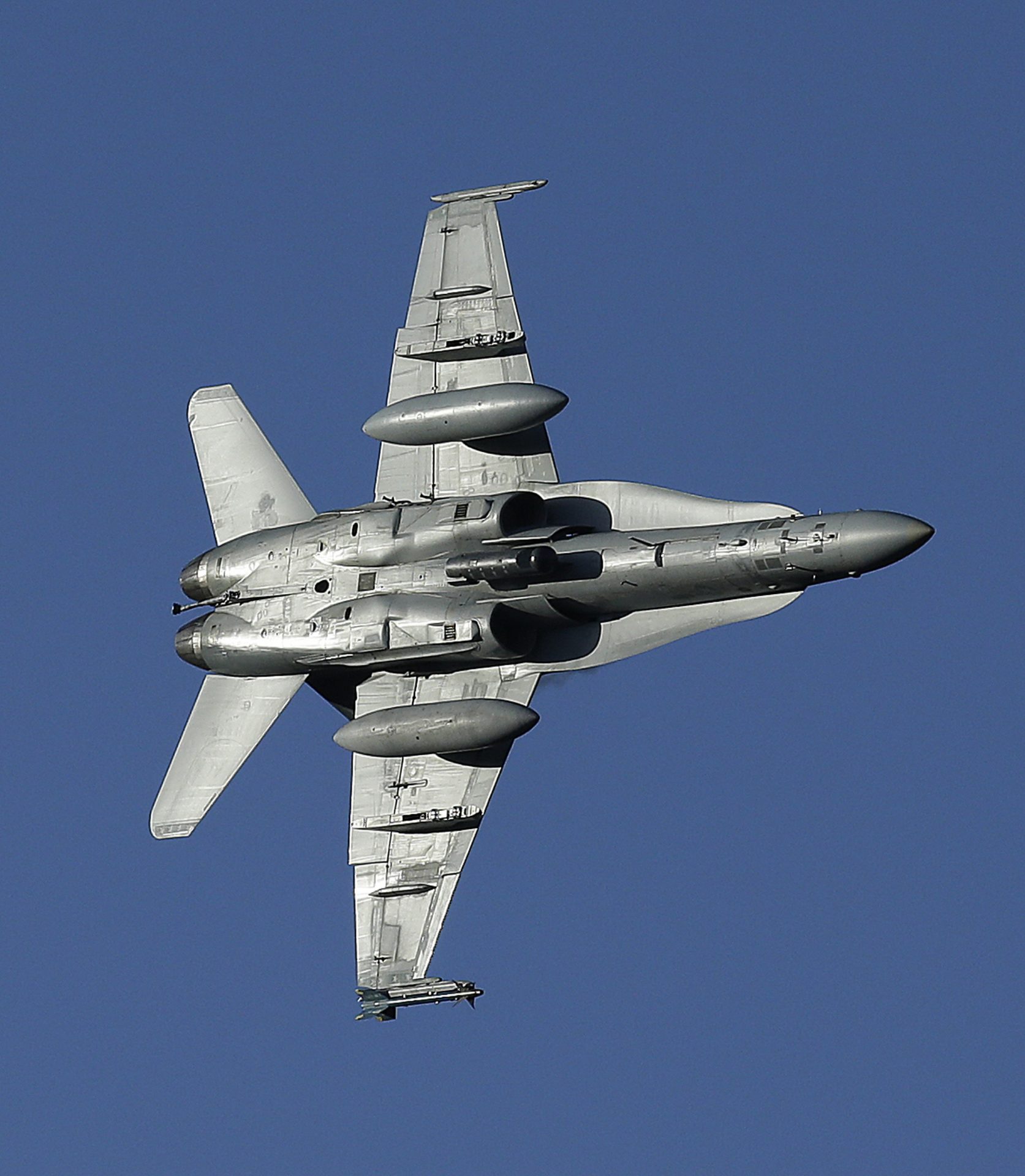 In this Feb. 27, 2017, photo, an F/A-18D Hornet with the VX-9 Vampire squadron from Naval Air Weapons Station, China Lake, banks over the nicknamed Star Wars Canyon in Death Valley National Park, Calif.