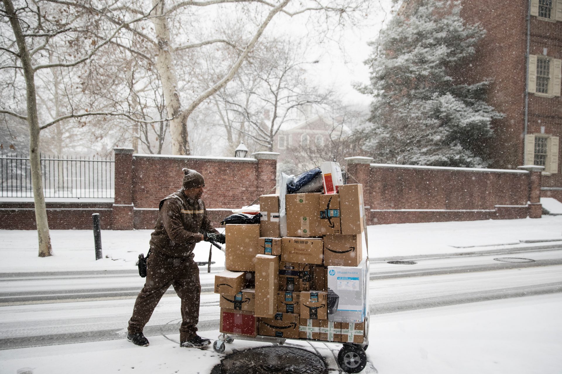 In this Dec. 15, 2017, file photo, a United Parcel Service worker makes his deliveries during a snowstorm in Philadelphia.
