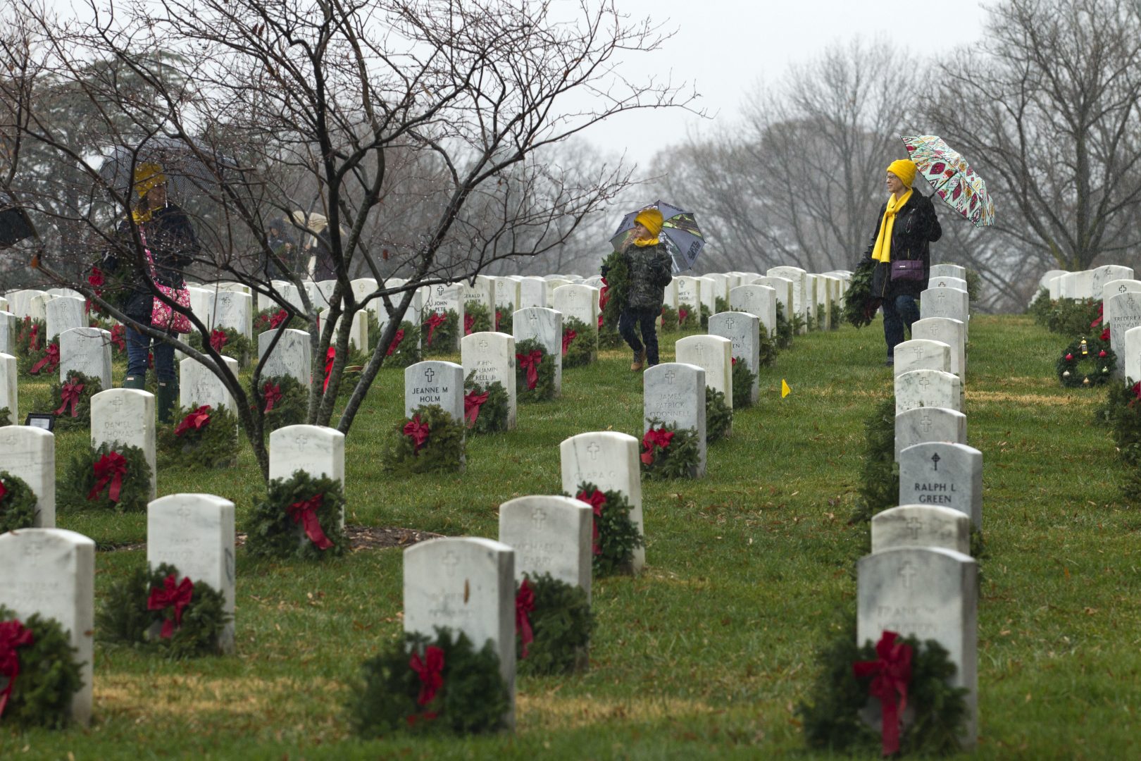Volunteers help to lay holiday wreaths at graves at Arlington National Cemetery in Arlington, Va., Saturday Dec. 15, 2018, during Wreaths Across America Day. Wreaths Across America was started in 1992 at Arlington National Cemetery by Maine businessman Morrill Worcester and has expanded to hundreds of veterans' cemeteries and other locations in all 50 states and beyond. (AP Photo/Jose Luis Magana)